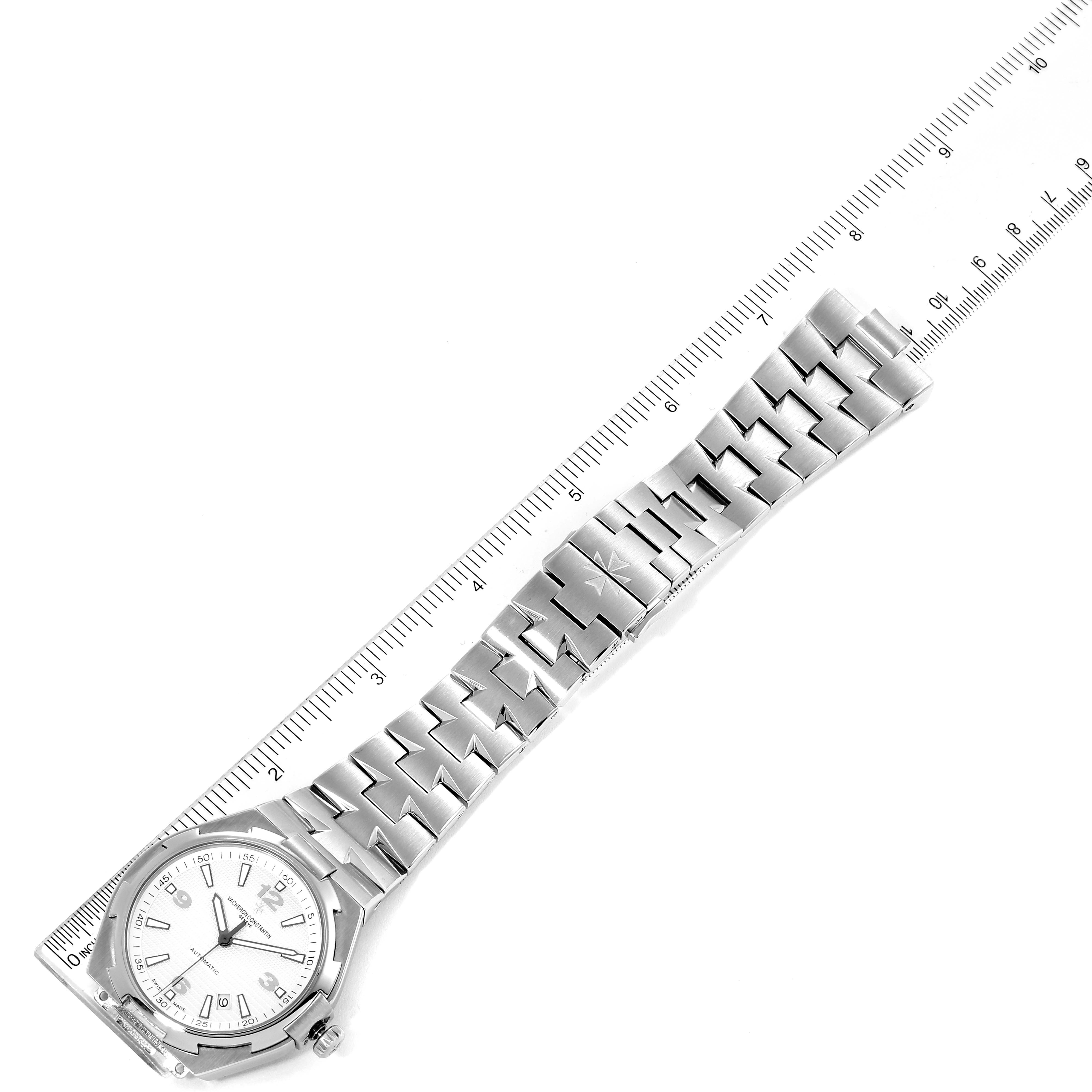 The image shows a Vacheron Constantin Overseas 47040B01A-9093 Men's Stainless Steel Silver Dial 47040B01A-9093 Men's Stainless Steel Silver Dial model watch, viewed from above, highlighting its face and bracelet alongside a ruler for scale.