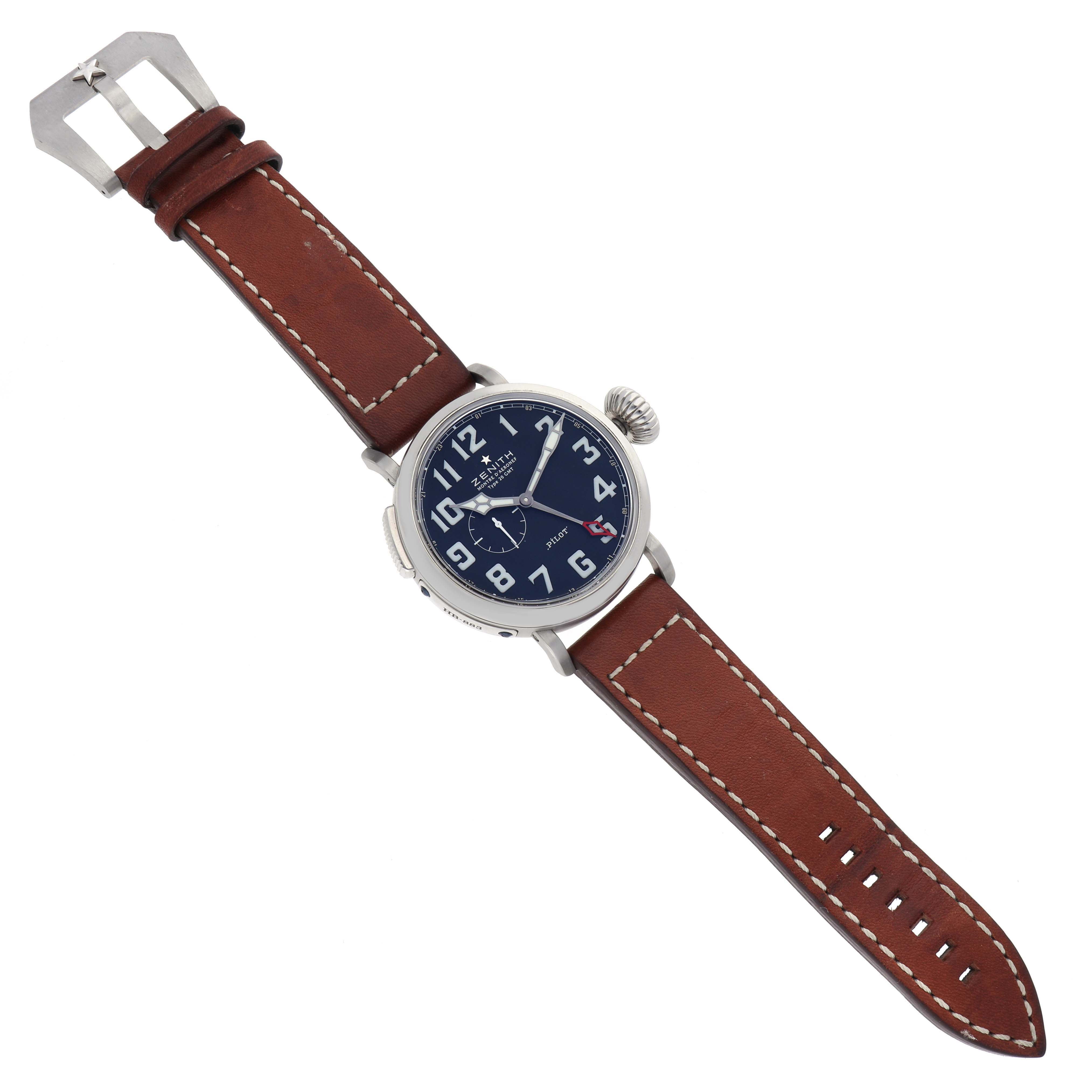 The Zenith Pilot 03.2430.693 Men
s Stainless Steel Black Dial watch is shown from a top-down angle, displaying its brown leather strap and blue dial with white numerals.
