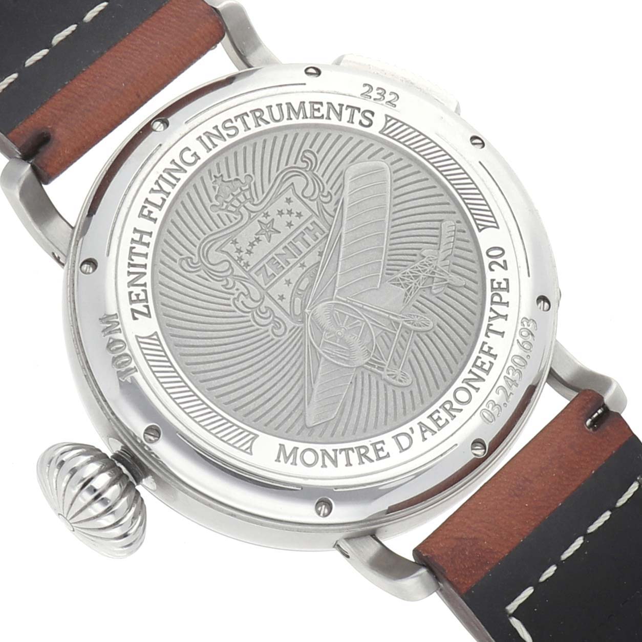The image shows the back of the Zenith Pilot 03.2430.693 Men
s Stainless Steel Black Dial watch, featuring engravings and the watch
s leather strap and crown.