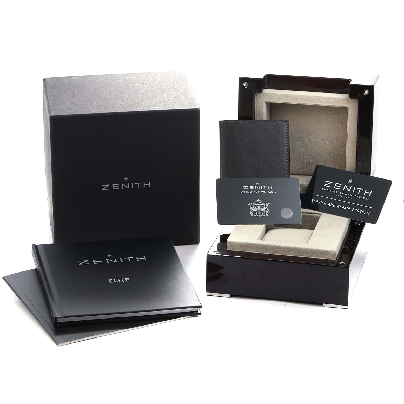 The image shows the Zenith Pilot 03.2430.693 Men
s Stainless Steel Black Dial watch packaging including a box, warranty cards, booklets, and a watch case from a front angle.