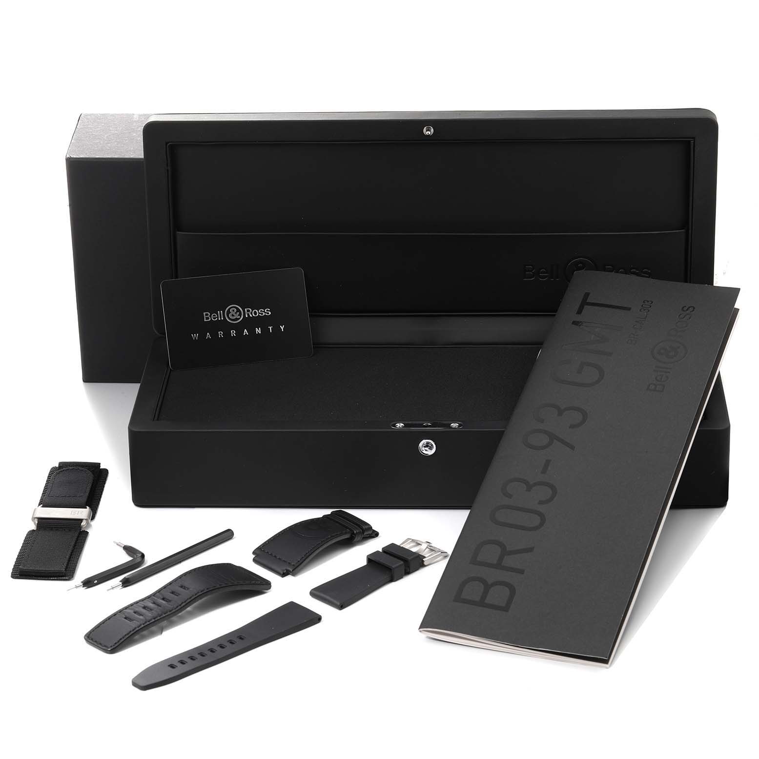 The image shows the packaging, warranty card, user manual, and various straps for the Bell & Ross Aviation GMT Black Dial Steel Mens Watch BR0393.
