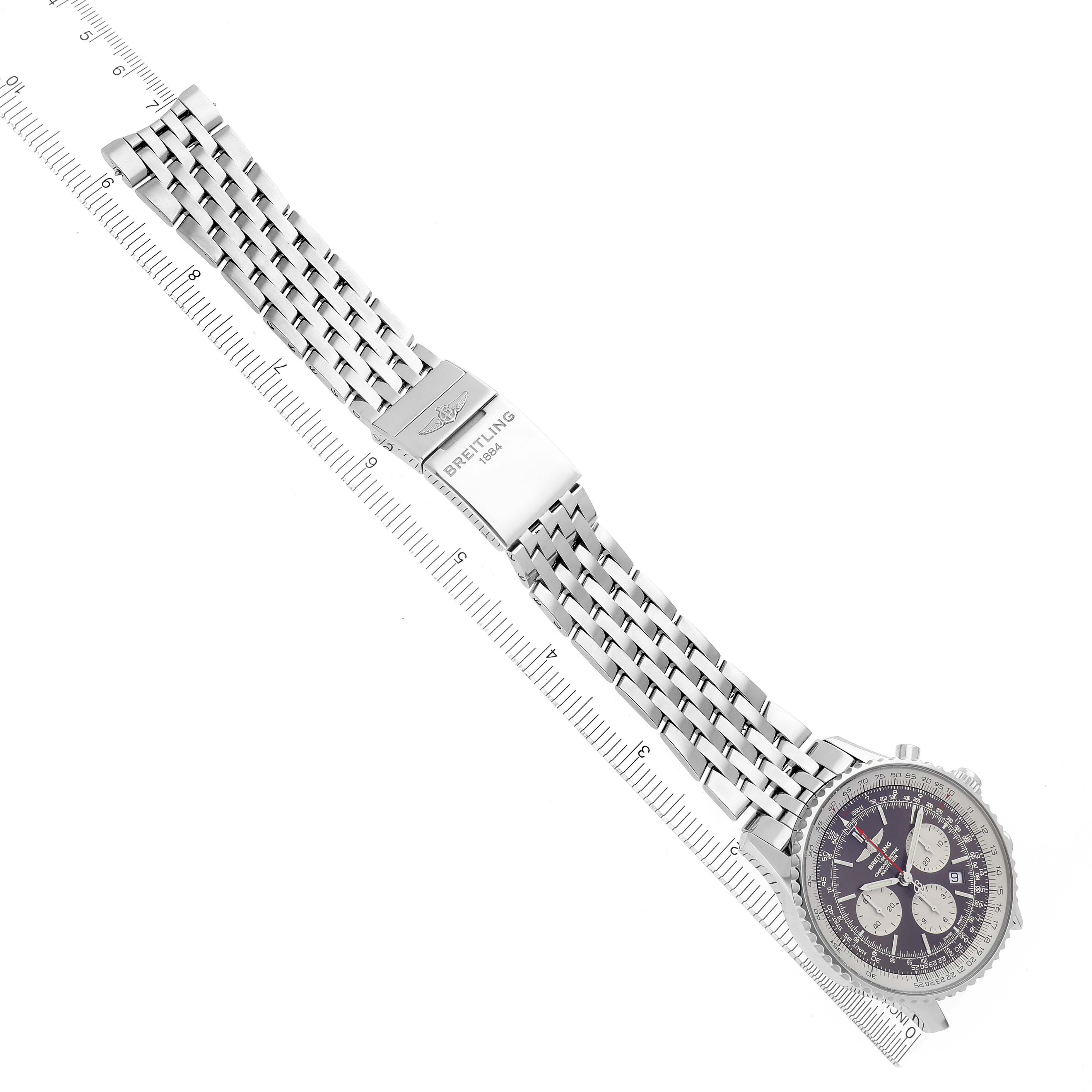 The image shows a Breitling Navitimer AB031021/Q615 Men's Stainless Steel Brown Dial AB031021/Q615 Men's Stainless Steel Brown Dial watch laid flat with its stainless steel bracelet fully extended next to a ruler.