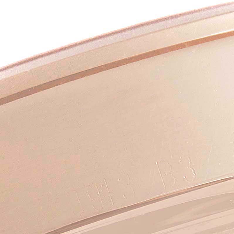 This image shows a close-up of the edge of the casing for the Breitling Transocean R45310 Men's Rose Gold Silver Dial R45310 Men's Rose Gold Silver Dial model watch, featuring its engraved details.