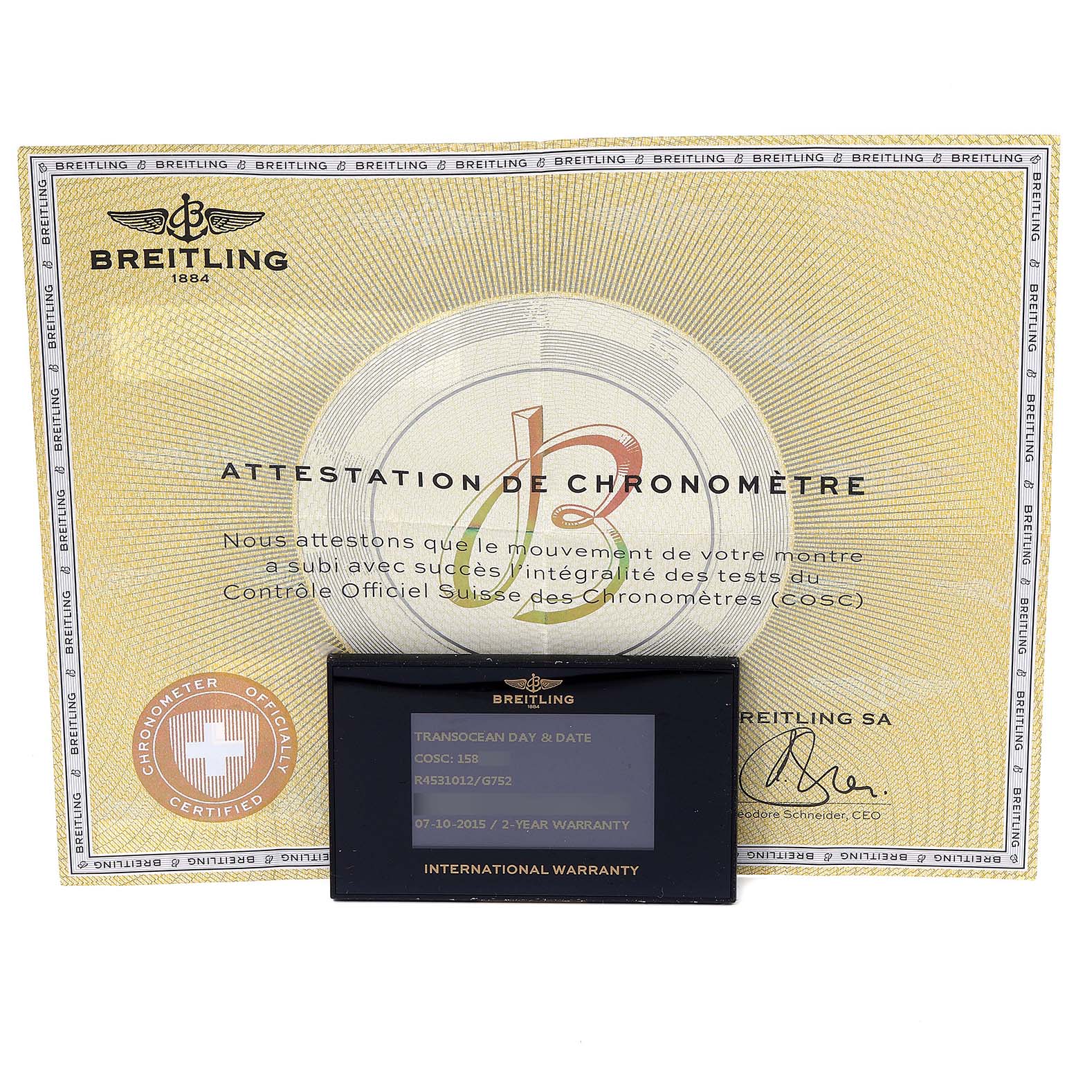 The image shows a Breitling Transocean R45310 Men's Rose Gold Silver Dial R45310 Men's Rose Gold Silver Dial watch's certificate and international warranty card, both photographed from above.