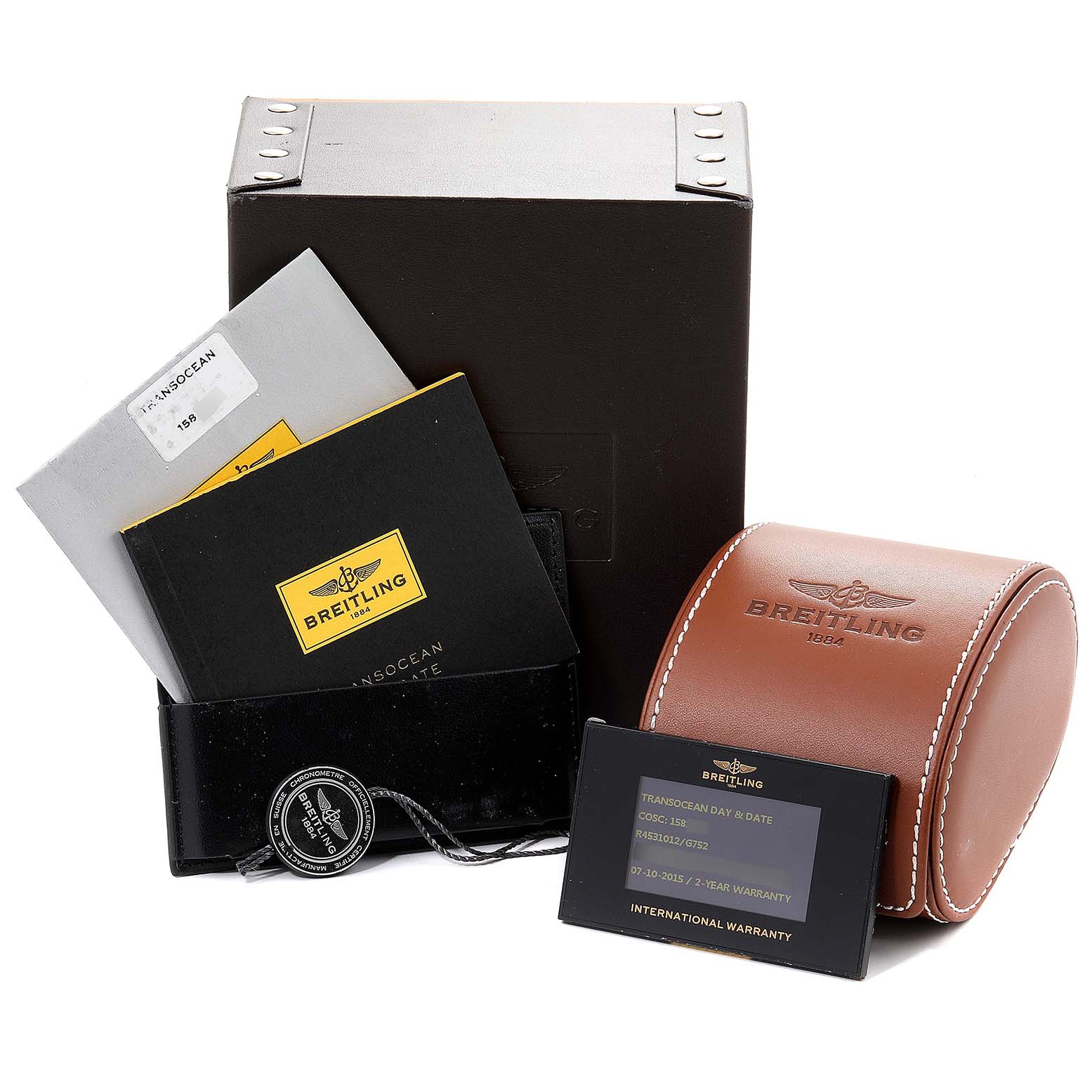 This image shows the packaging and accessories for a Breitling Transocean R45310 Men's Rose Gold Silver Dial R45310 Men's Rose Gold Silver Dial watch, including the box, documents, and warranty card.
