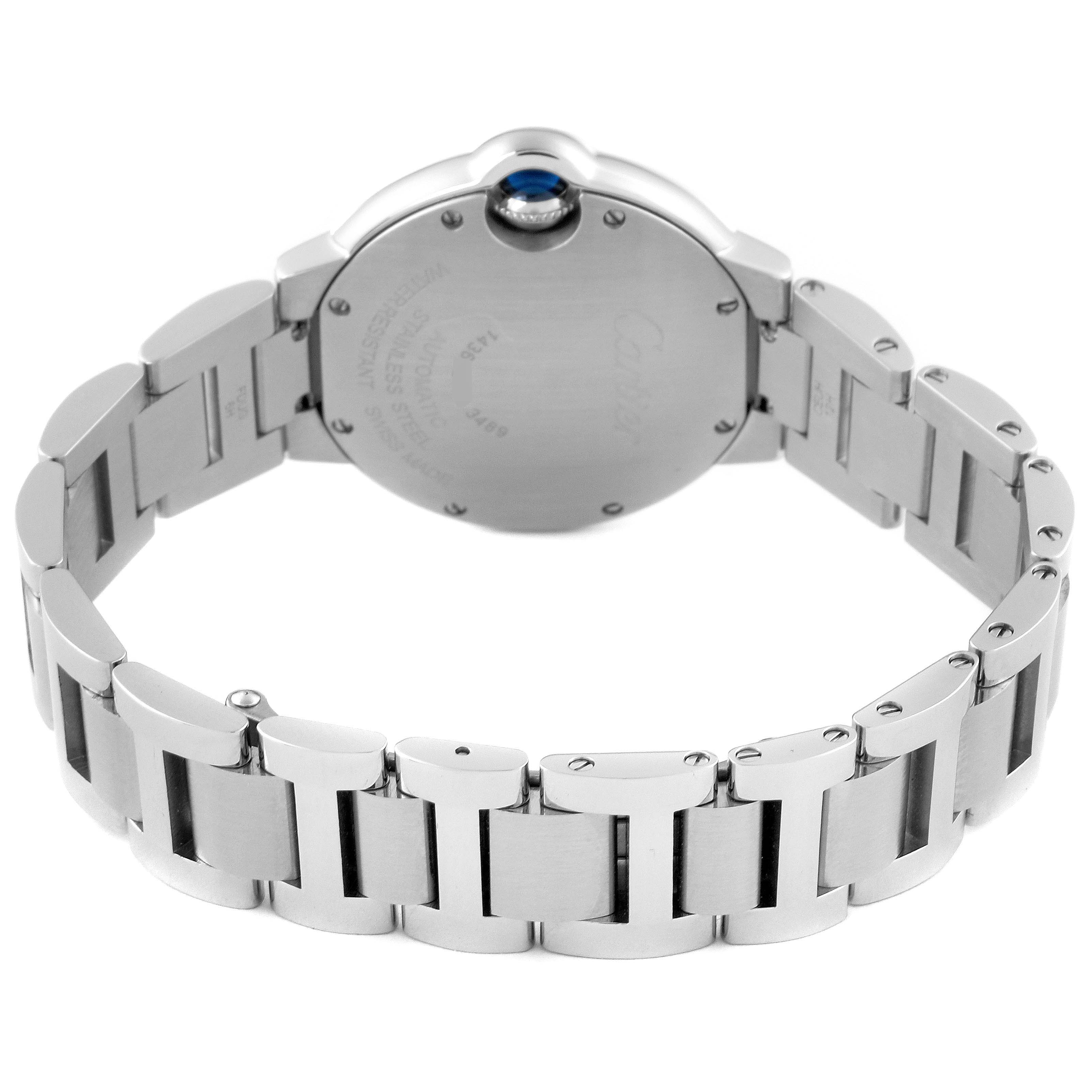 The image shows the back view of a Ballon Bleu de Cartier watch, highlighting the stainless steel bracelet and case back.