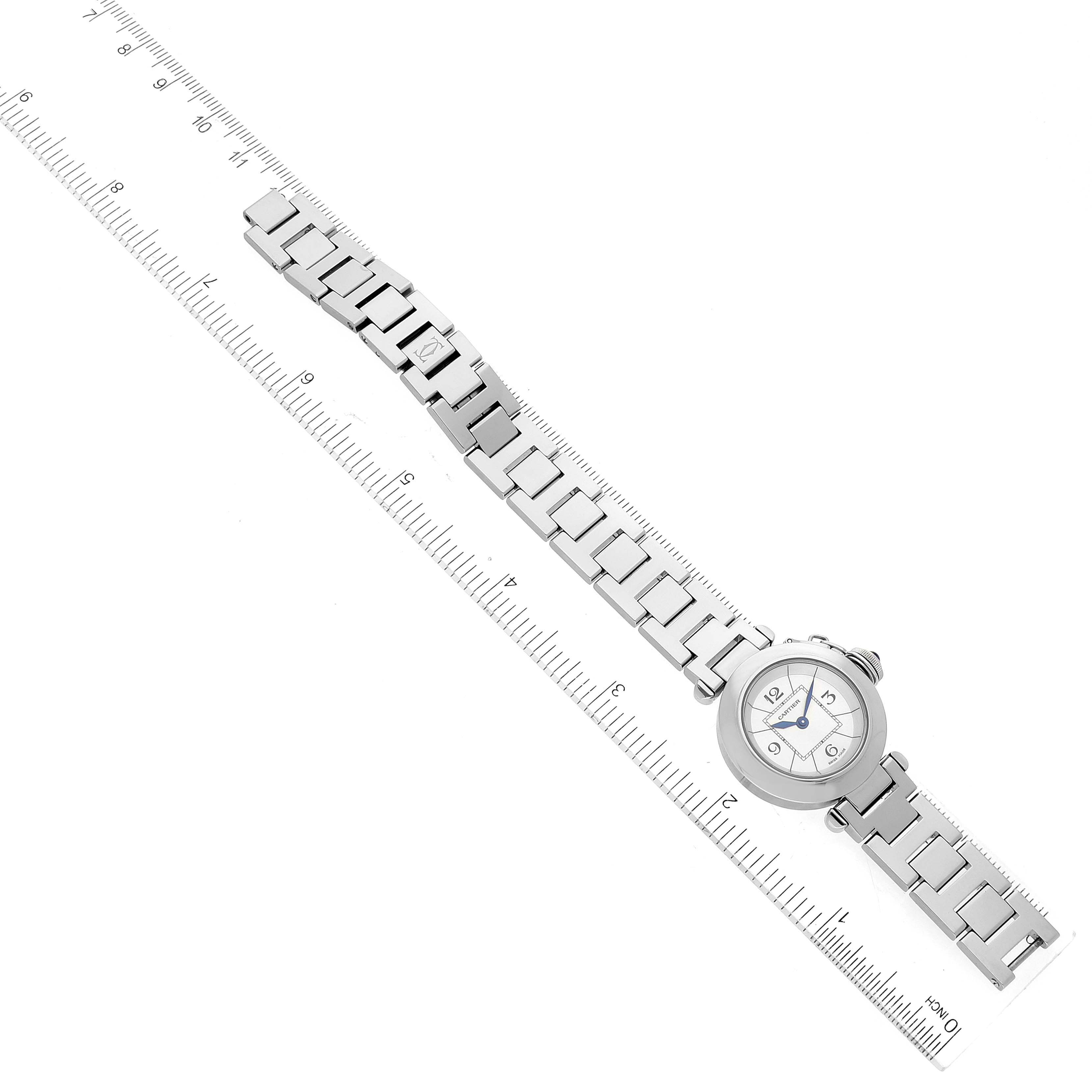 The image shows a Cartier Pasha W3140007 Women's Stainless Steel Silver Dial W3140007 Women's Stainless Steel Silver Dial model watch laid flat, with the face and full metal bracelet visible, next to a ruler for scale.