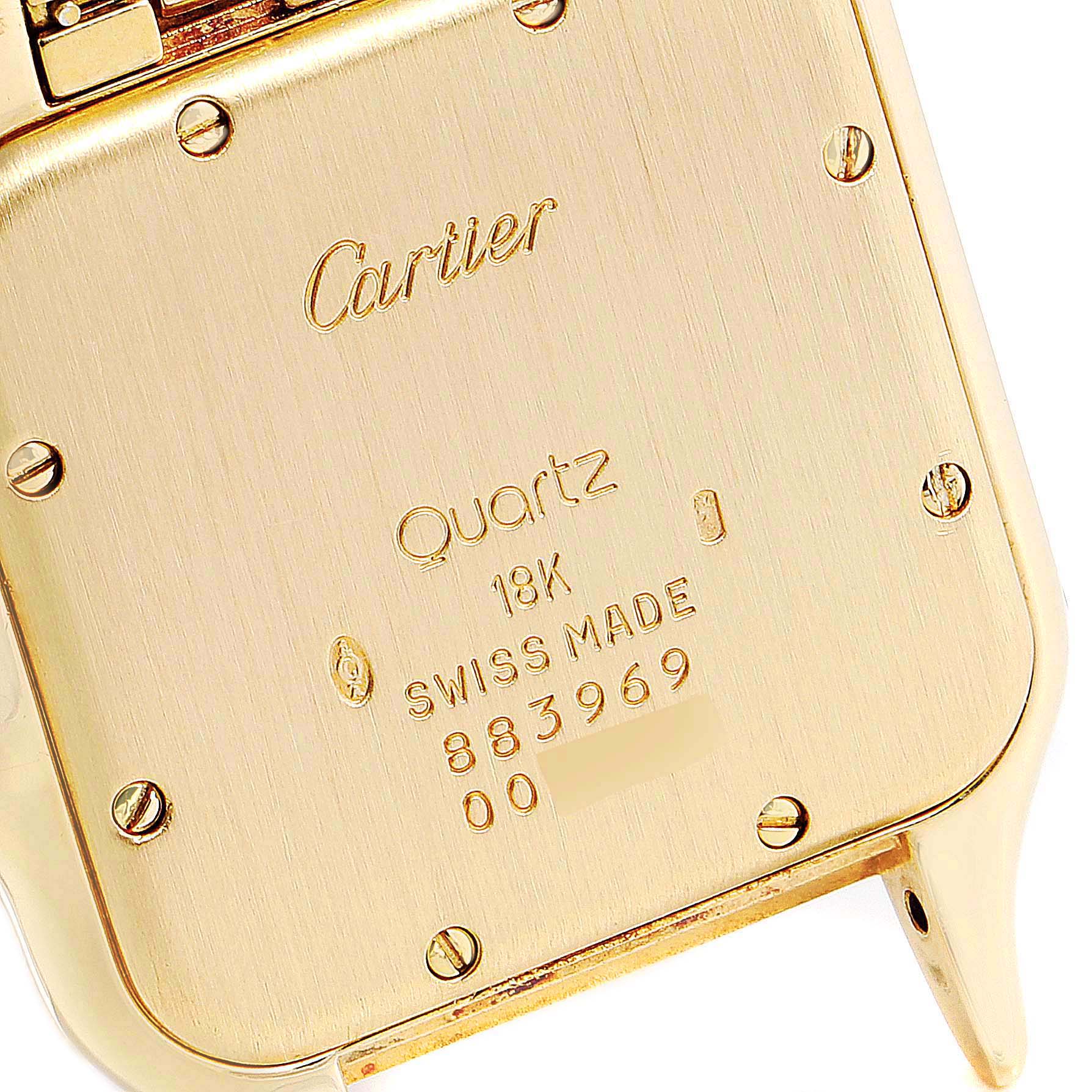 The image shows the back case of a Cartier Panthere 883969 Women's Yellow Gold Champagne Dial 883969 Women's Yellow Gold Champagne Dial watch, highlighting its inscriptions and screws.