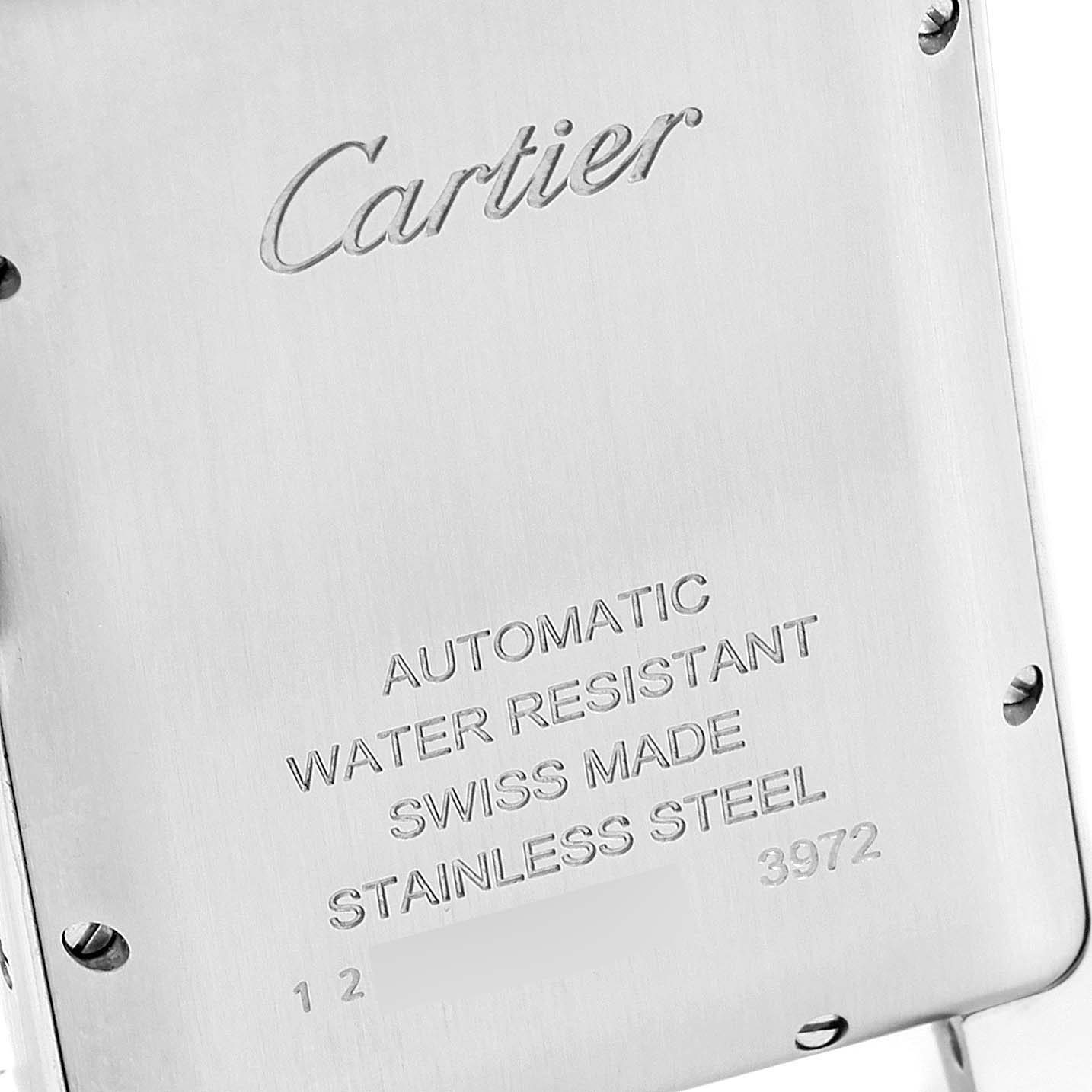 This image shows the back case of a Tank Americaine model by Cartier, highlighting its specifications and brand engraving.