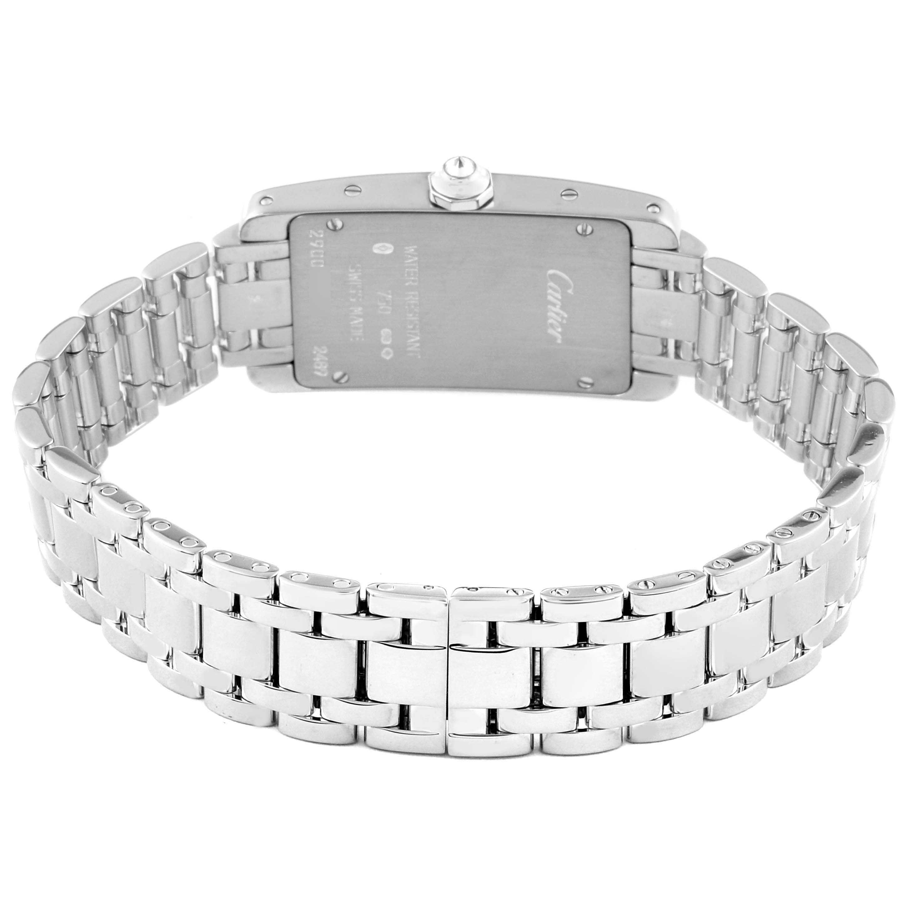 The image shows the back of the Tank Américaine model watch by Cartier, highlighting its case back and metal bracelet.