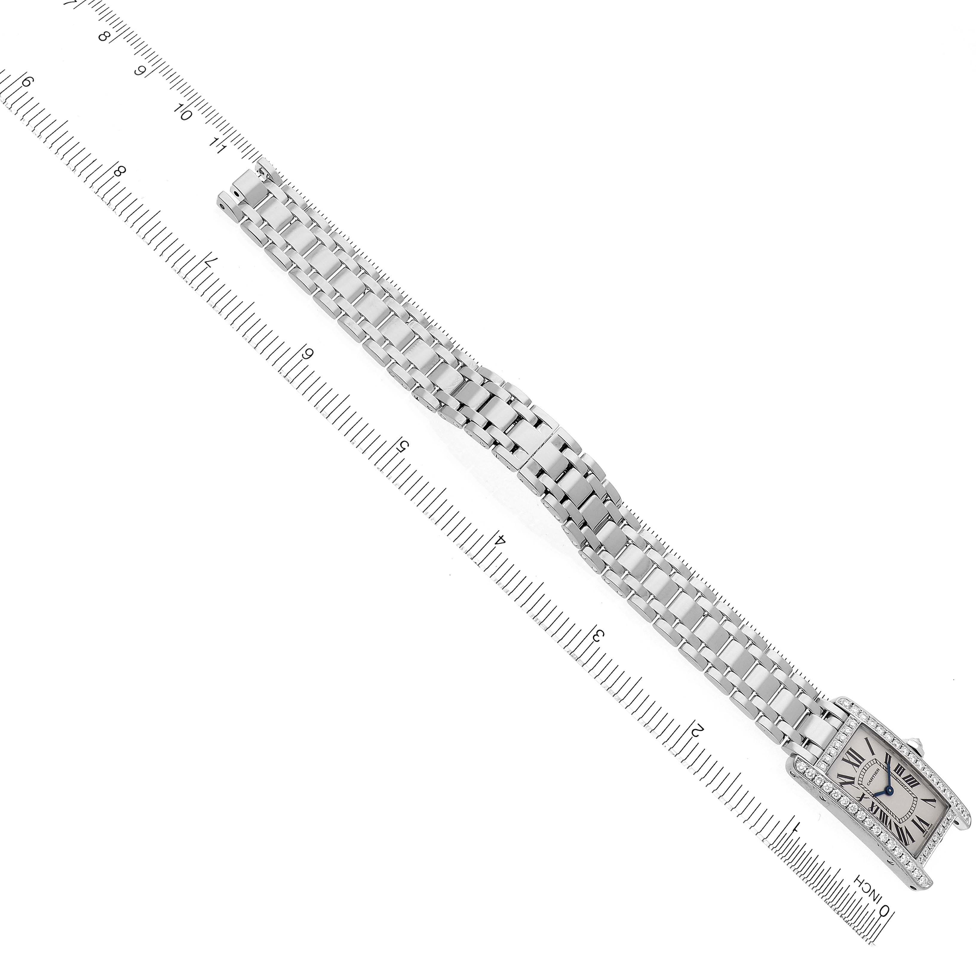 This image shows a Cartier Tank Americaine WB7073L1 Women's White Gold Silver Dial WB7073L1 Women's White Gold Silver Dial watch laid flat with a ruler for size reference, prominently displaying the bracelet and face.
