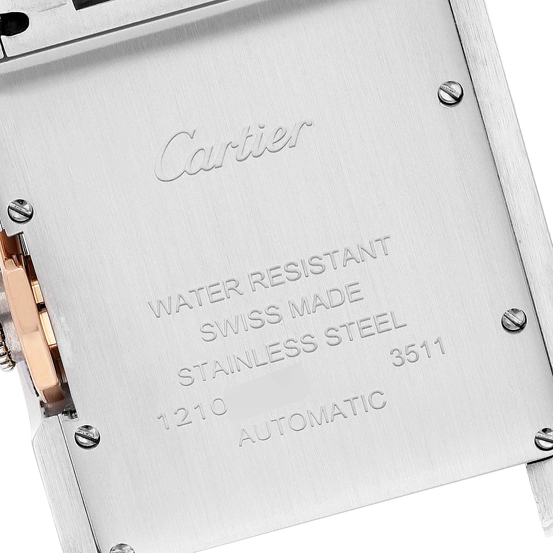 The image shows an angled close-up of the reverse side of a Cartier Tank Anglaise WT100025 Women
s Steel and Gold (two tone) Silver Dial WT100025 Women
s Steel and Gold (two tone) Silver Dial watch, displaying engraved text and parts of the caseback.