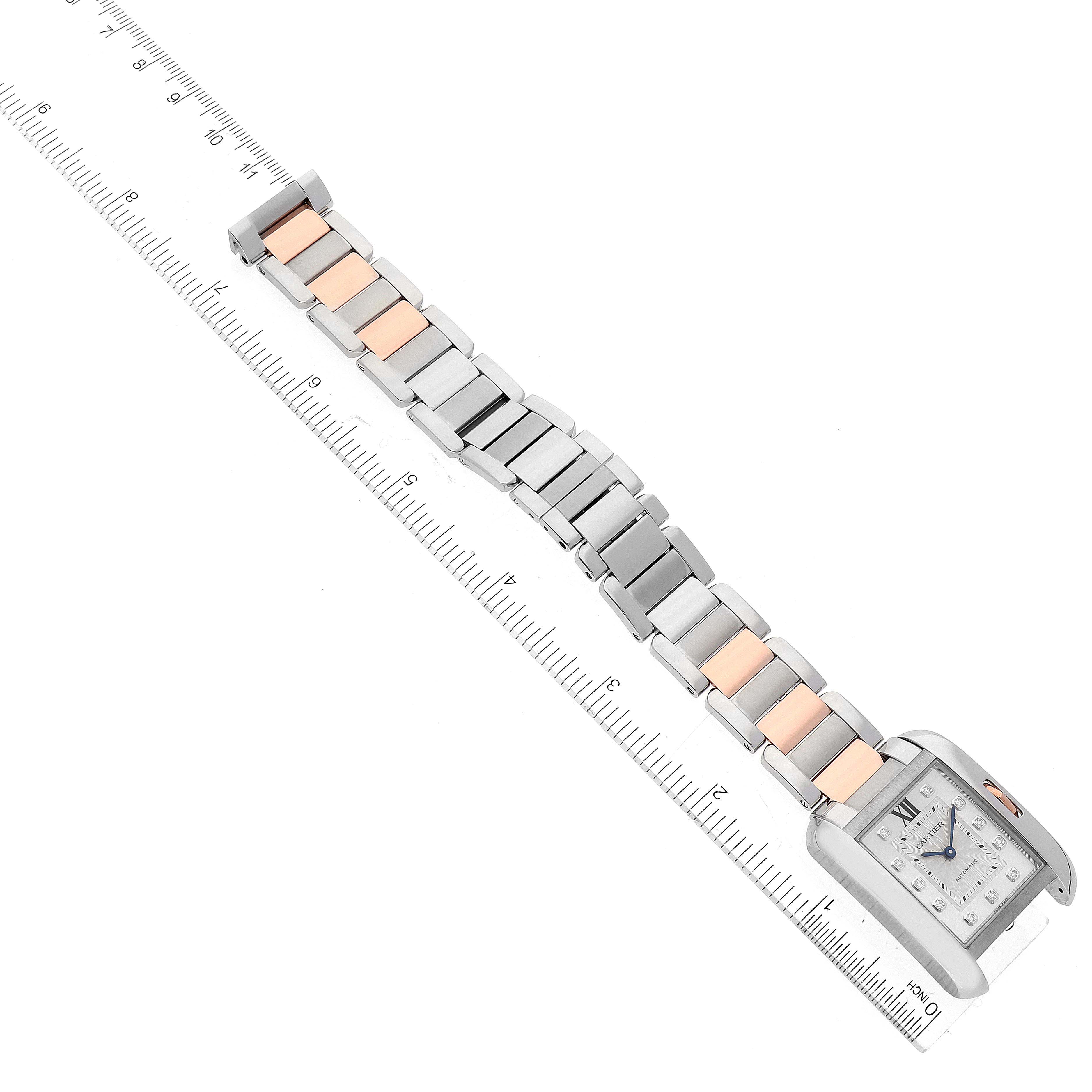 The Cartier Tank Anglaise WT100025 Women
s Steel and Gold (two tone) Silver Dial WT100025 Women
s Steel and Gold (two tone) Silver Dial watch is shown laid flat, showcasing the face, bracelet, and clasp, with a ruler for scale.
