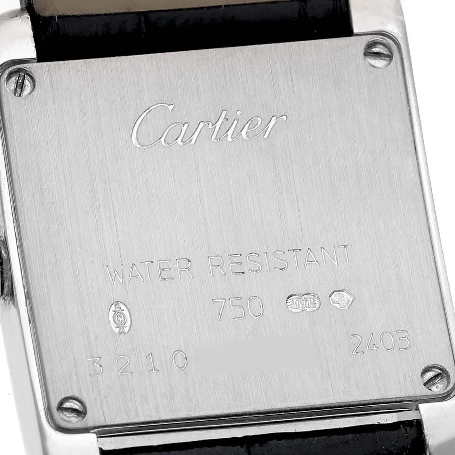 The image shows the case back of a Cartier Tank Française watch, displaying brand engravings and serial numbers.