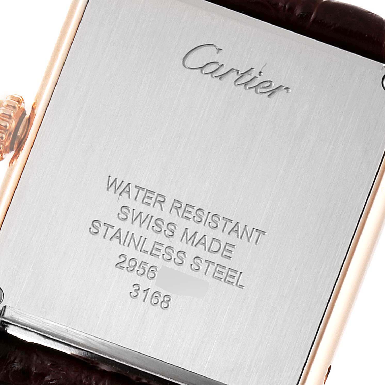 The image shows the back case of a Cartier Tank Solo W5200024 Women's Rose Gold Silver Dial W5200024 Women's Rose Gold Silver Dial watch, highlighting inscriptions about material and water resistance.