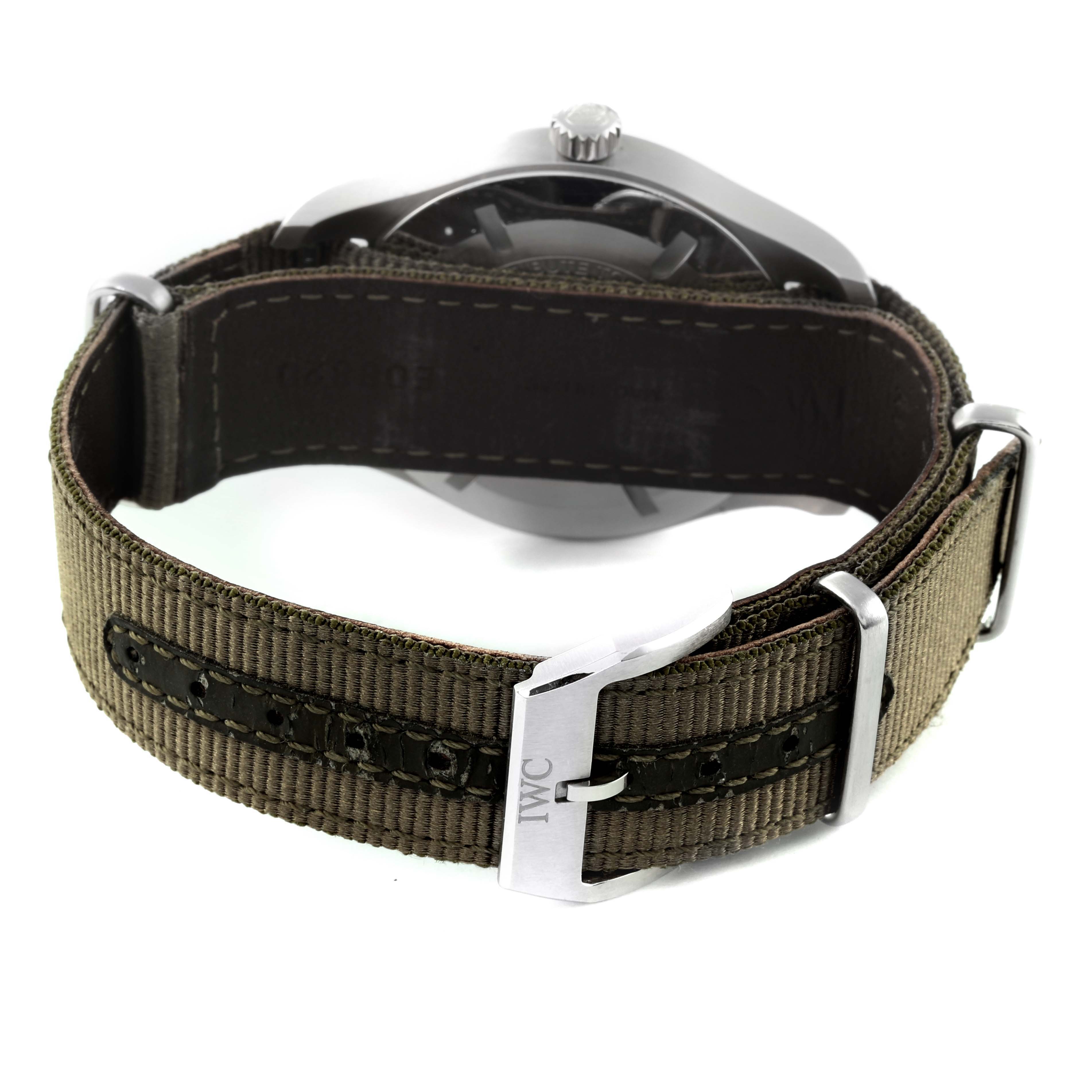 The image shows the backside and strap of an IWC Pilot IW327007 Men's Stainless Steel Black Dial IW327007 Men's Stainless Steel Black Dial model watch, featuring a canvas and stitched leather band with a metal buckle.