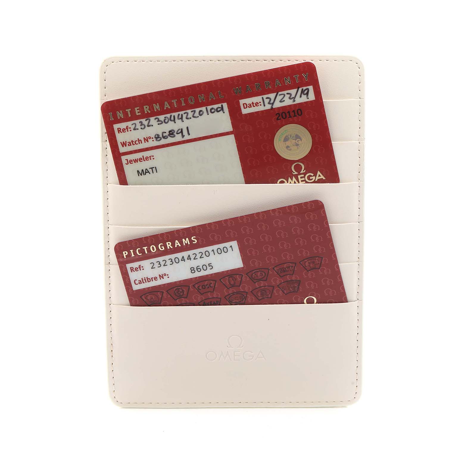 The image shows warranty and pictogram cards for the Omega Planet Ocean 232.30.44.22.01.001 Men
s Stainless Steel Black Dial watch in a cream cardholder.