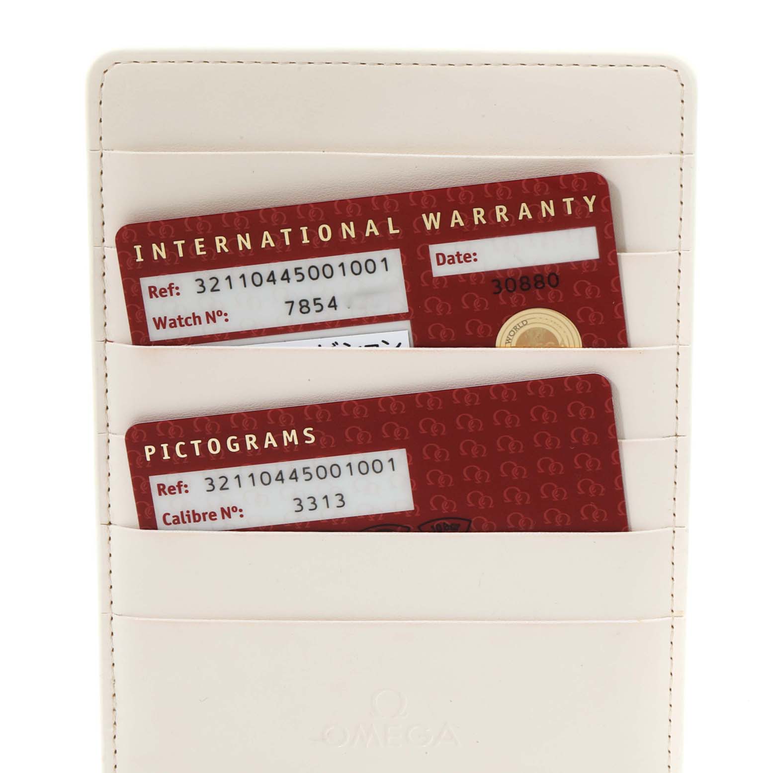 The image shows the warranty and pictograms cards for the Omega Speedmaster 321.10.44.50.01.001 Men
s Stainless Steel Black Dial 321.10.44.50.01.001 Men
s Stainless Steel Black Dial placed in a cardholder.