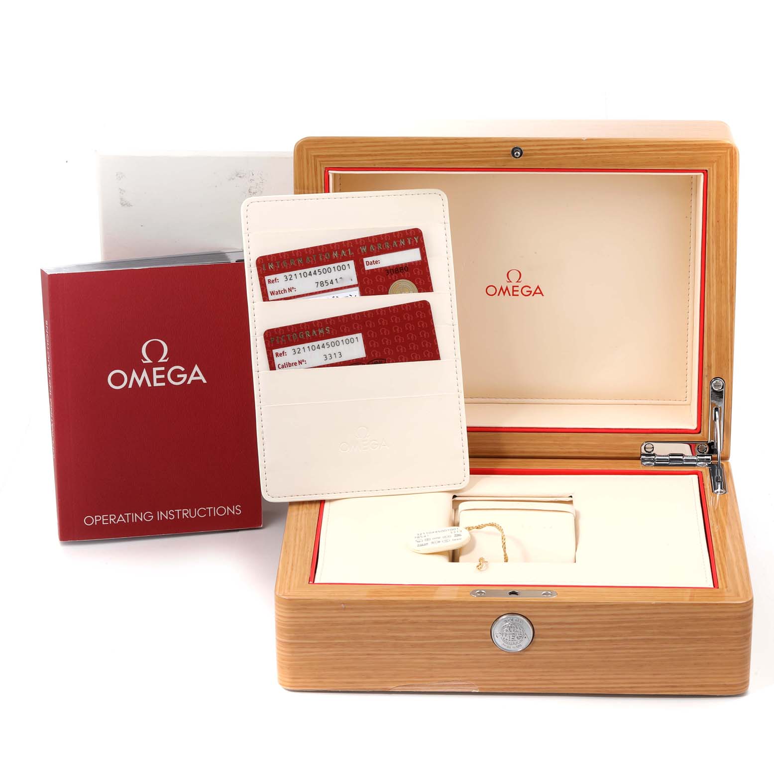 The image shows an Omega Speedmaster 321.10.44.50.01.001 Men
s Stainless Steel Black Dial 321.10.44.50.01.001 Men
s Stainless Steel Black Dial watch box, warranty cards, and an operating instructions booklet viewed from the front.