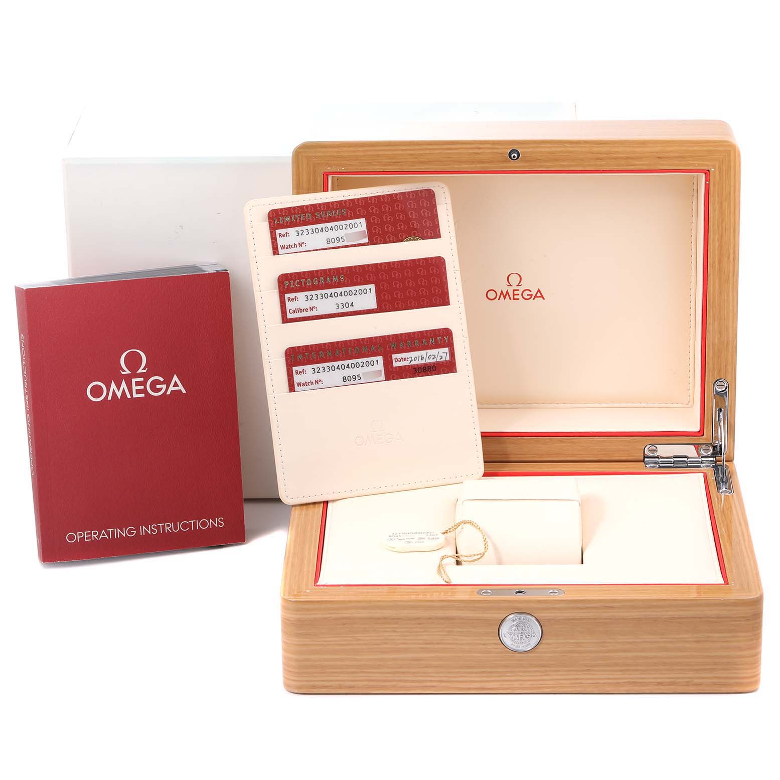 This image shows an Omega Speedmaster 323.30.40.40.02.001 Men's Stainless Steel White Dial 323.30.40.40.02.001 Men's Stainless Steel White Dial box with operating instructions, warranty cards, and a key.