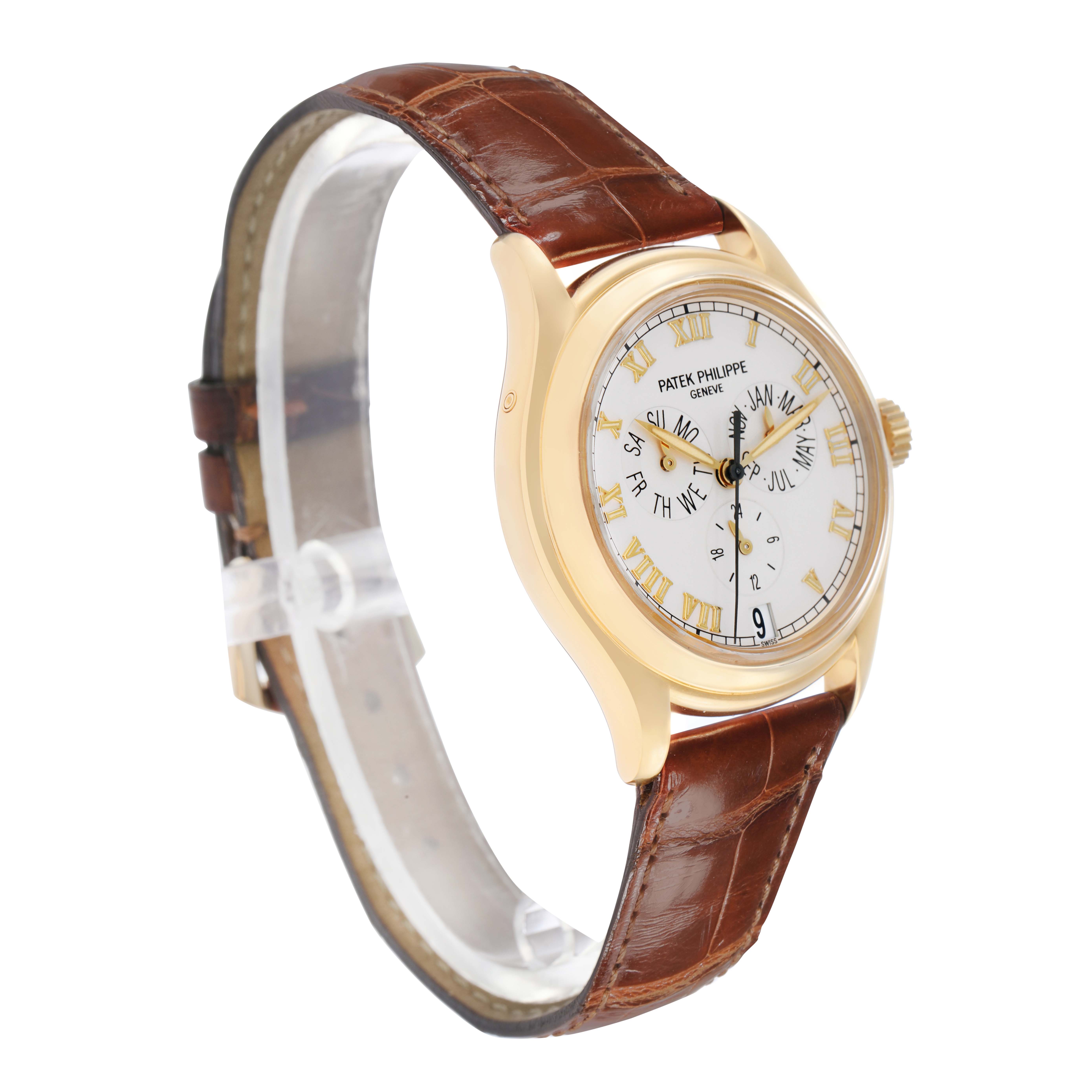 The Patek Philippe Complications 5035J Men
s Yellow Gold White Dial watch is shown at a three-quarter angle, highlighting the face, case, and brown leather strap.