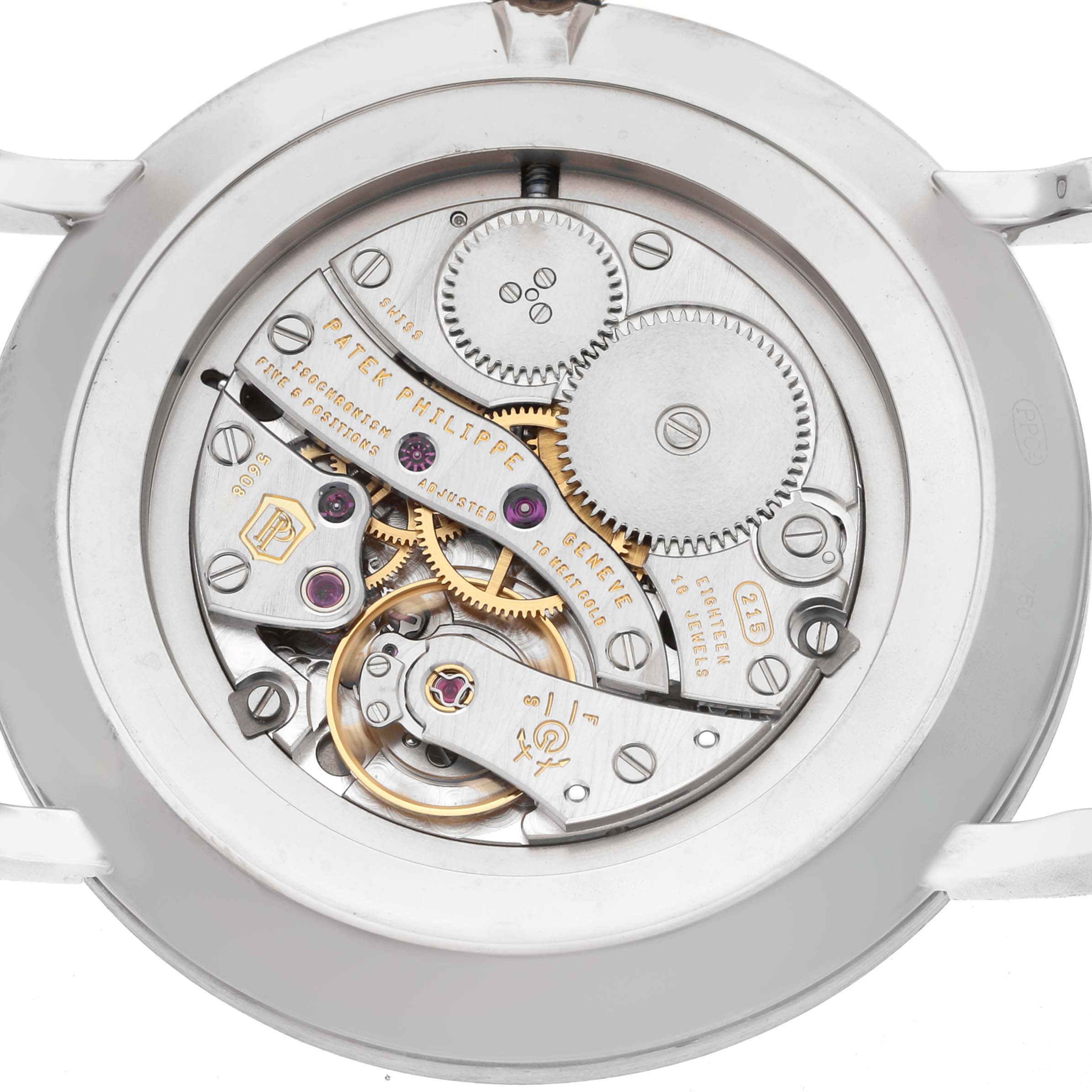 The image shows the movement of a Patek Philippe Calatrava 5119G-001 Men
s White Gold White Dial model from the back, highlighting gears and inner mechanics.