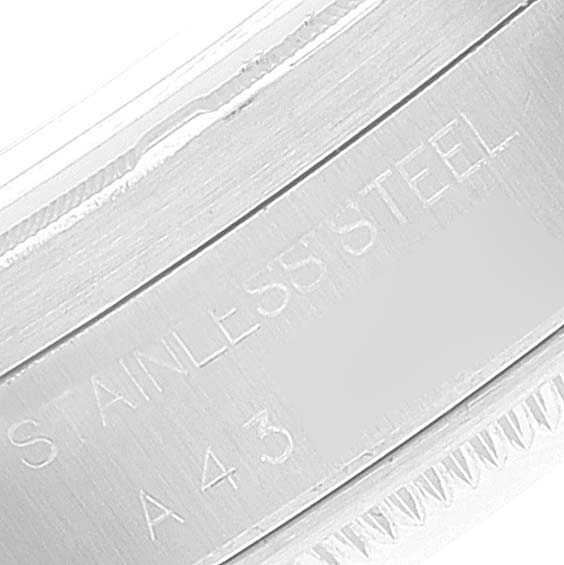 The image shows a close-up of the case back edge with "STAINLESS STEEL" engraving on a Rolex Date 15210 Men's Stainless Steel Black Dial 15210 Men's Stainless Steel Black Dial model watch.