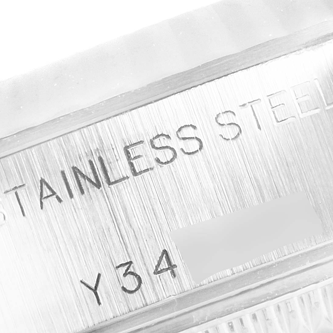 The image shows a close-up of the engraved details on the stainless steel back of a Rolex Datejust 79174 Women's Stainless Steel Silver Dial 79174 Women's Stainless Steel Silver Dial watch.