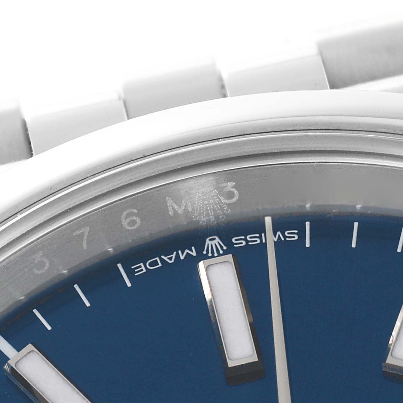 This image shows a close-up of the dial and part of the bracelet of a Rolex Datejust 126200 Men's Stainless Steel Blue Dial 126200 Men's Stainless Steel Blue Dial watch, focusing on the "Swiss Made" text and hour markers.
