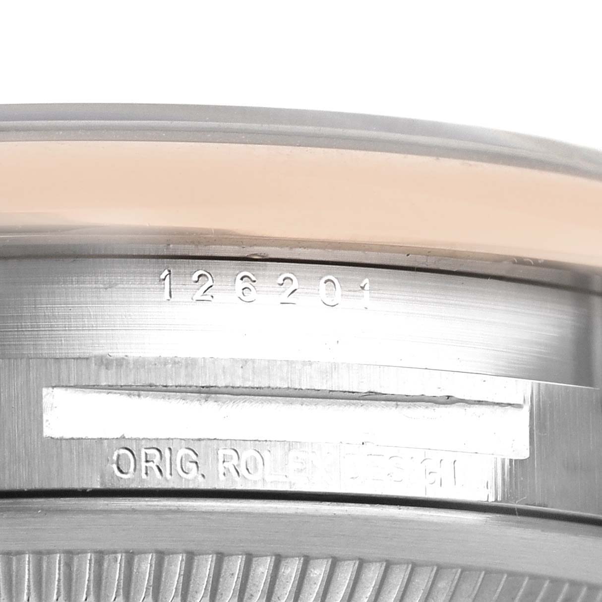 This image shows a close-up view of the model number and part of the bezel of a Rolex Datejust 126201 Men
s Steel and Gold (two tone) White Dial 126201 Men
s Steel and Gold (two tone) White Dial watch.