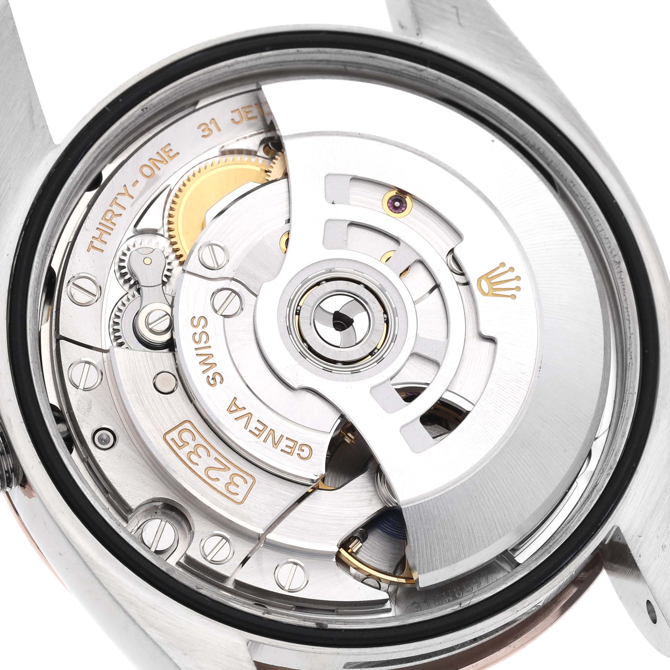 This is a close-up view of the movement and internal components of the Rolex Datejust 126201 Men
s Steel and Gold (two tone) White Dial 126201 Men
s Steel and Gold (two tone) White Dial watch.