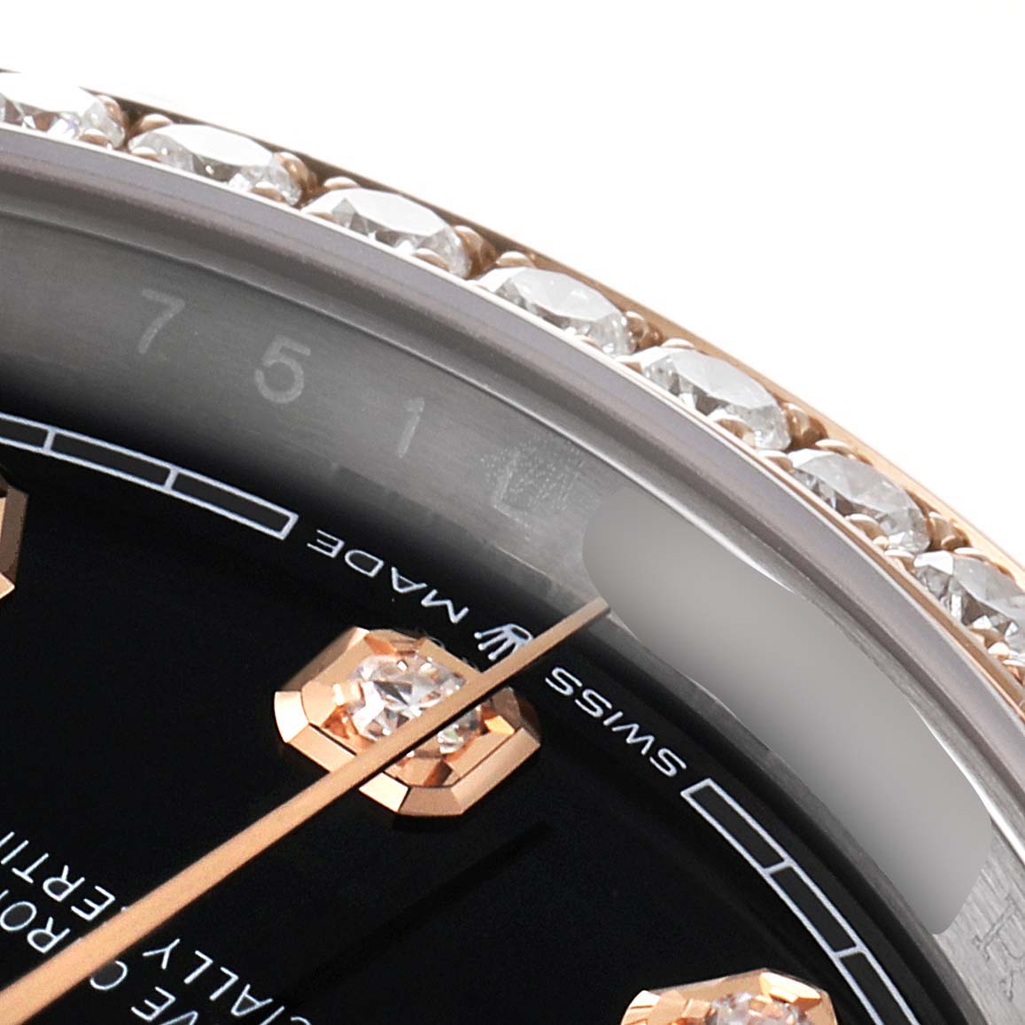 The image shows a close-up angle of the Rolex Datejust 126281 Men's Steel and Gold (two tone) Black Dial 126281 Men's Steel and Gold (two tone) Black Dial watch, highlighting its diamond-studded bezel and part of the dial with a gold hour marker.