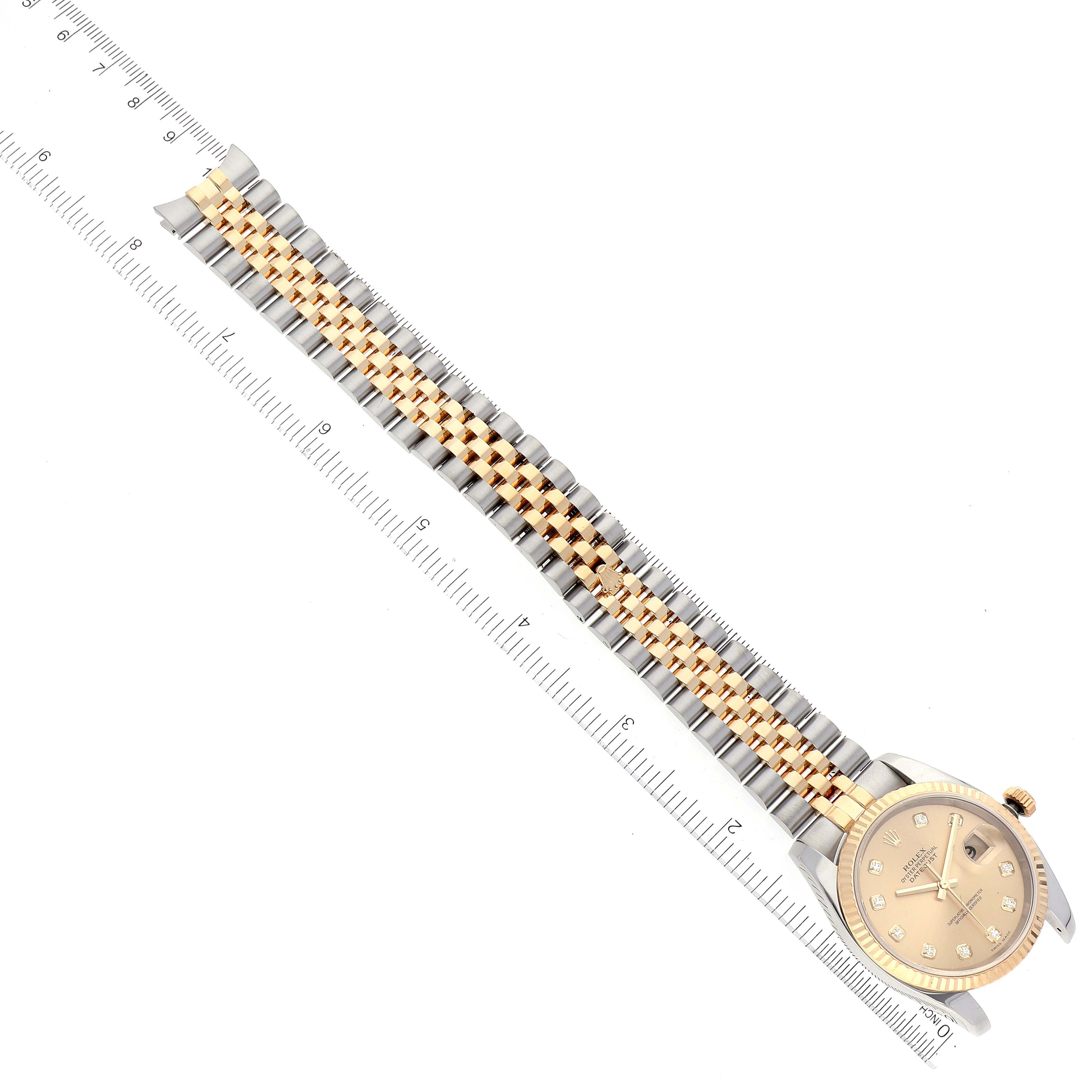 The image shows a Rolex Datejust 116233 Men's Steel and Gold (two tone) Champagne Dial 116233 Men's Steel and Gold (two tone) Champagne Dial watch lying flat with a ruler, highlighting the bracelet and face viewed from above.