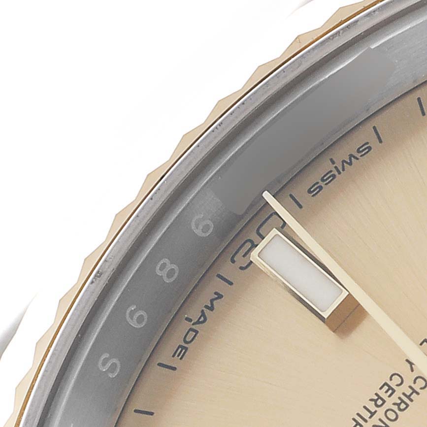 The image shows a close-up of a Rolex Datejust 41 126333 Men
s Steel and Gold (two tone) Champagne Dial, highlighting the edge of the dial, hour markers, and the bezel from a side angle.