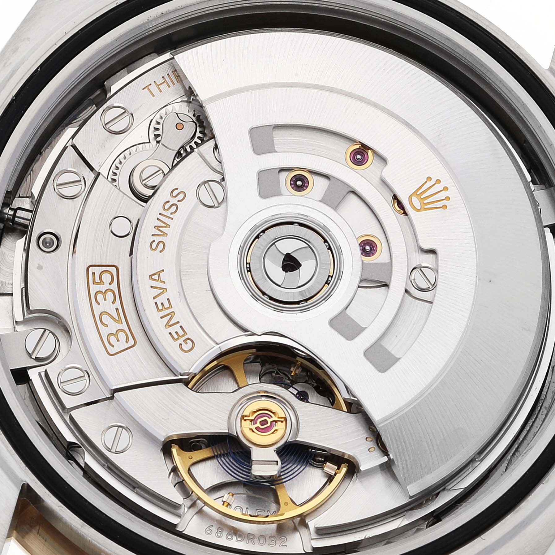 This close-up shows the movement mechanism of the Rolex Datejust 41 126303 Men's Steel and Gold (two tone) Grey Dial 126303 Men's Steel and Gold (two tone) Grey Dial, featuring the Geneva Seal and intricate components.