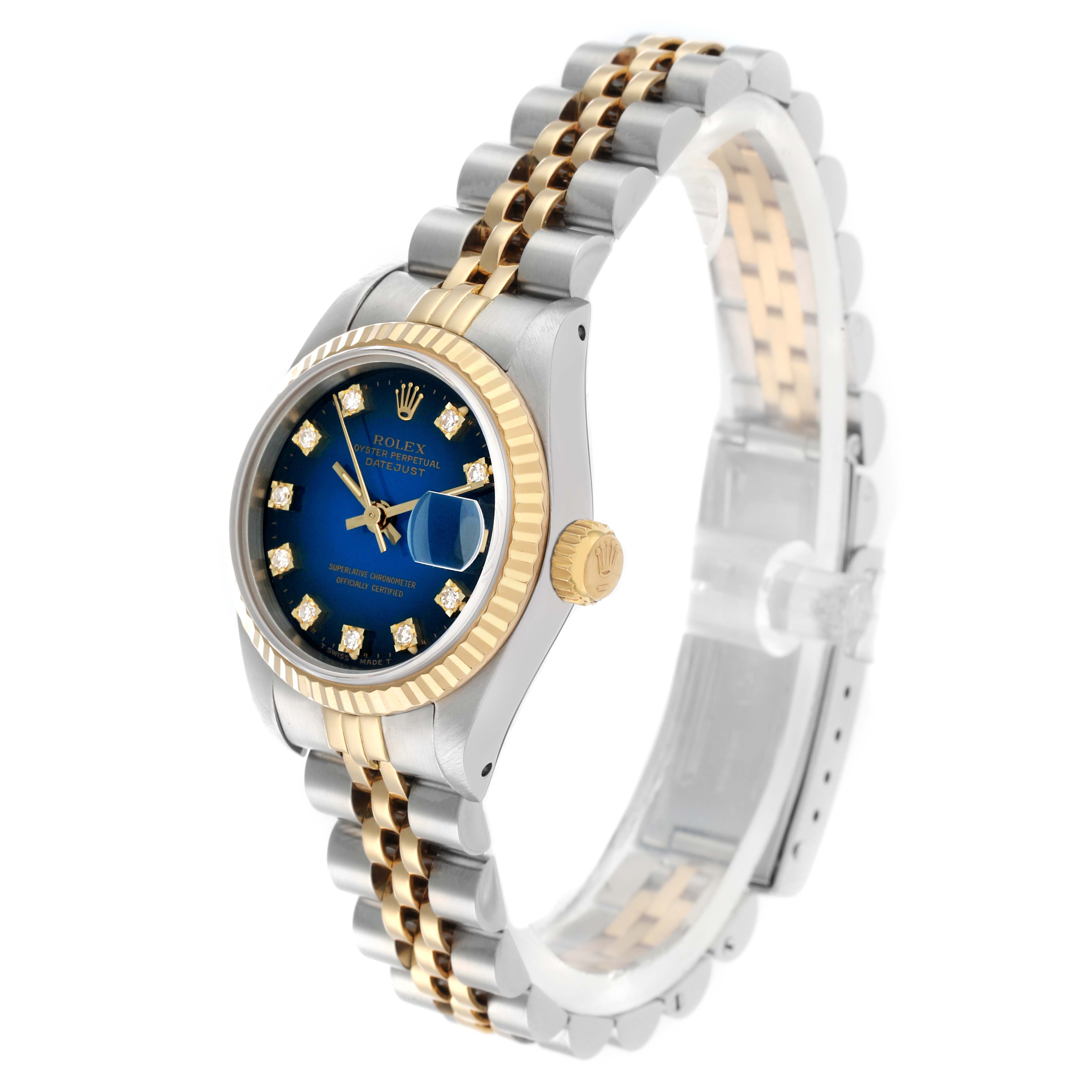 The image shows a Rolex Datejust 69173 Women
s Steel and Gold (two tone) Blue Dial watch at a three-quarter angle, highlighting its blue dial, gold bezel, and two-tone bracelet.