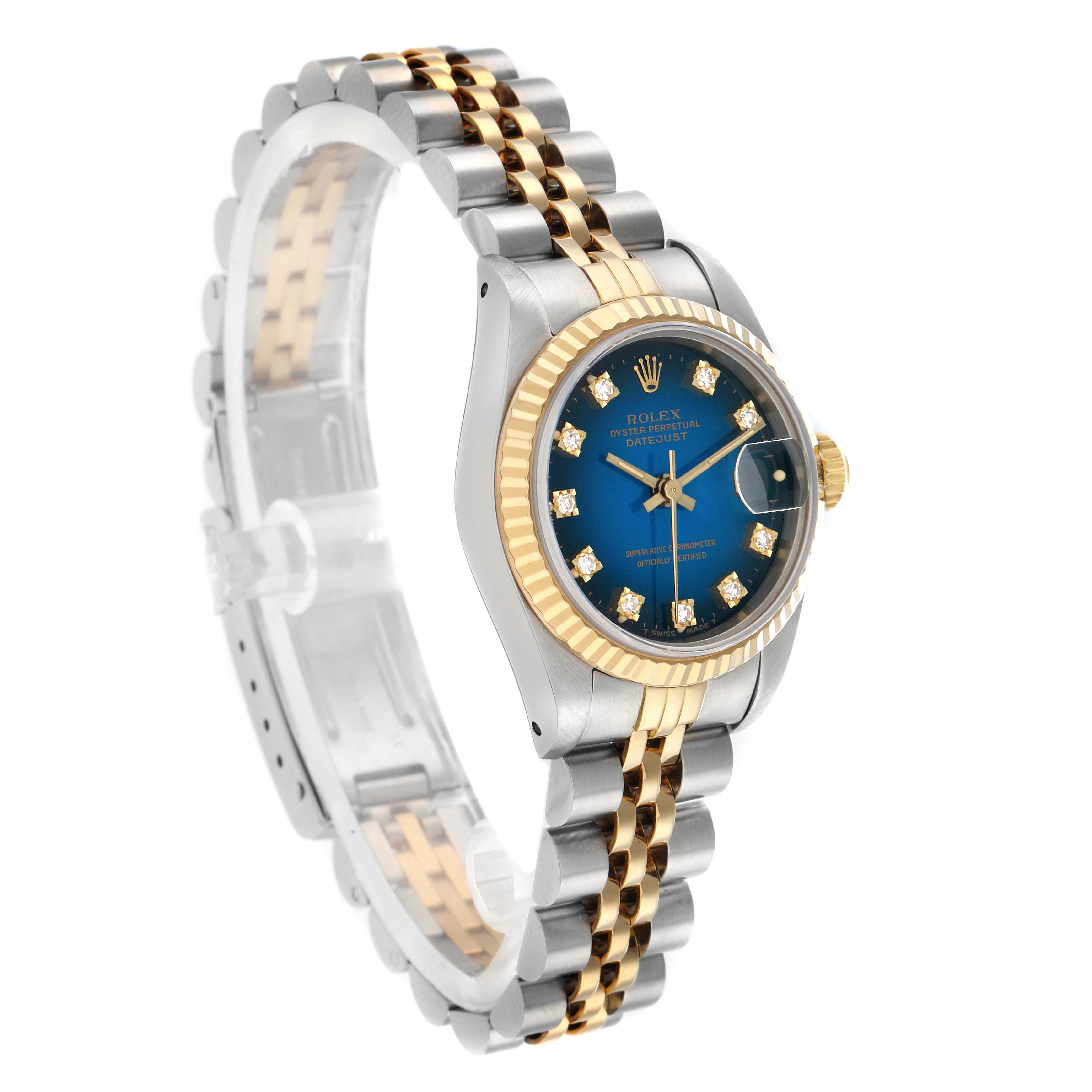 The Rolex Datejust 69173 Women
s Steel and Gold (two tone) Blue Dial watch is shown at a three-quarter angle, highlighting the blue dial, fluted bezel, and two-tone jubilee bracelet.