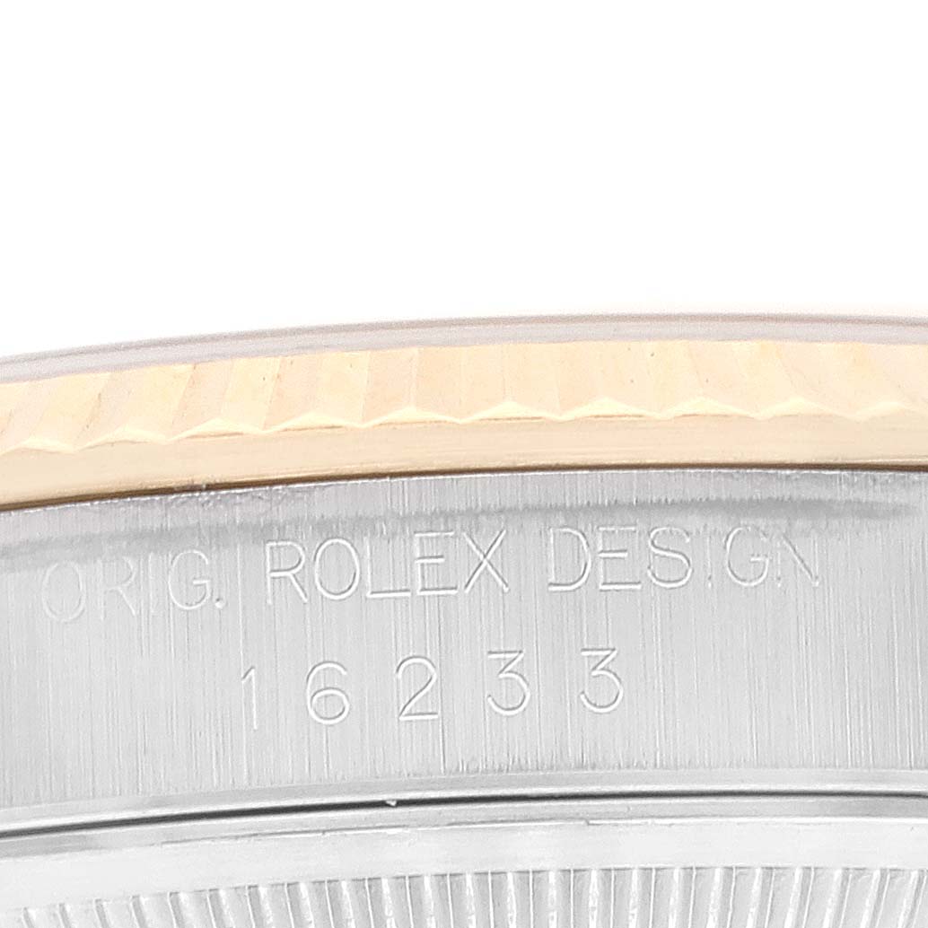 The image shows a close-up of the side of a Rolex Datejust 16233 Men's Steel and Gold (two tone) Champagne Dial 16233 Men's Steel and Gold (two tone) Champagne Dial watch, highlighting its engraved model number 16233 and bezel detail.