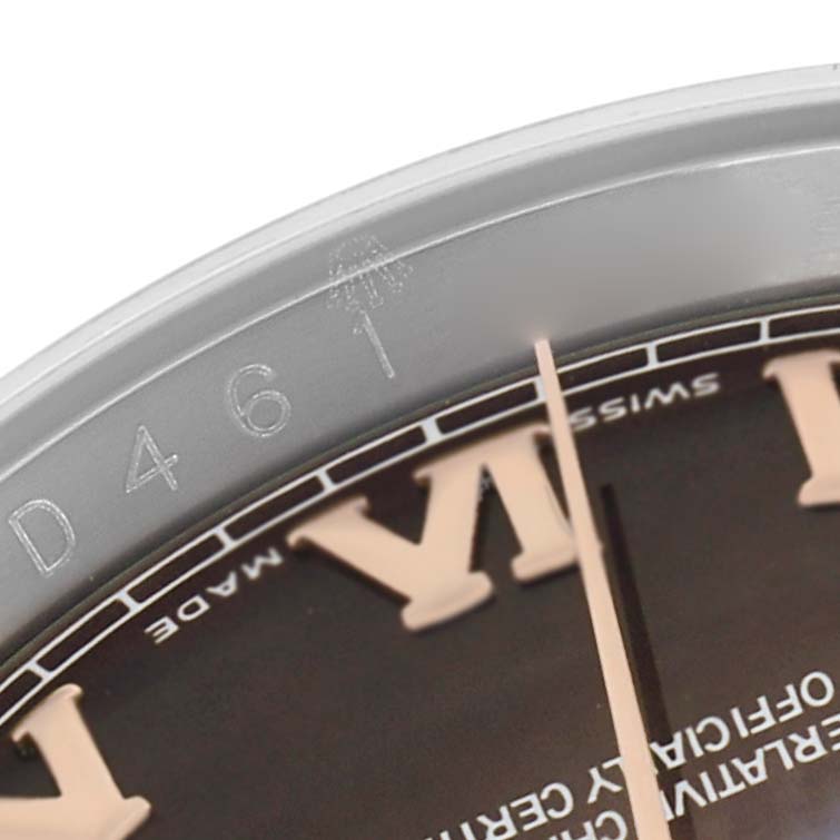 The image shows a close-up of the bezel and part of the dial of a Rolex Datejust 116231 Men
s Steel and Gold (two tone) Mother of Pearl Dial, highlighting the engraved details.