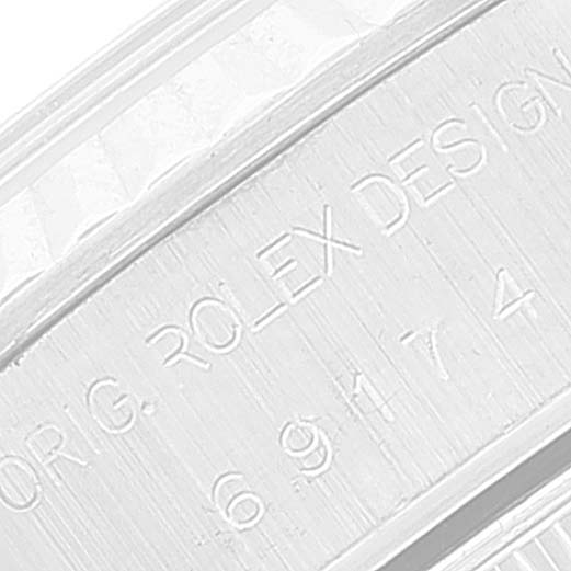 This close-up image of a Rolex Datejust 69174 Women
s Stainless Steel Blue Dial 69174 Women
s Stainless Steel Blue Dial watch shows the engraved serial number on the inner bezel.