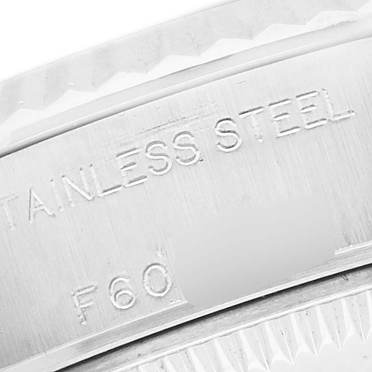 The image shows a close-up of the stainless steel bezel edge of a Rolex Datejust 79174 Women
s Stainless Steel Mother of Pearl Dial watch.