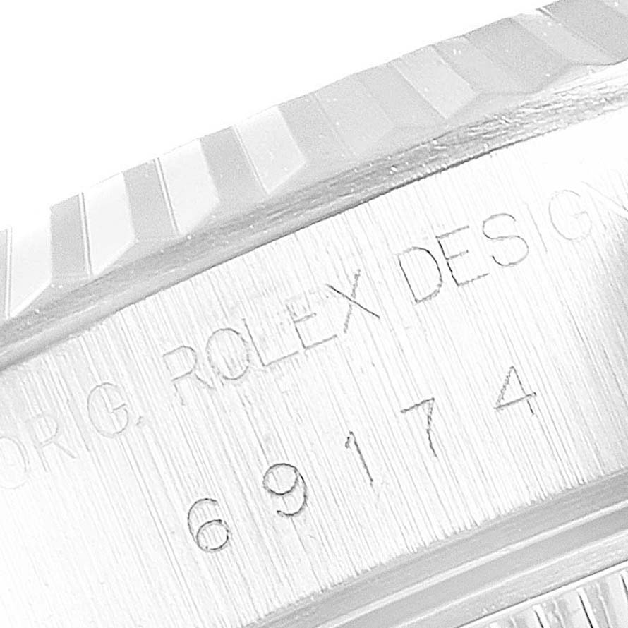 This is a close-up of the side engraving and edge of the bezel on a Rolex Datejust 69174 Women's Stainless Steel Silver Dial 69174 Women's Stainless Steel Silver Dial watch.