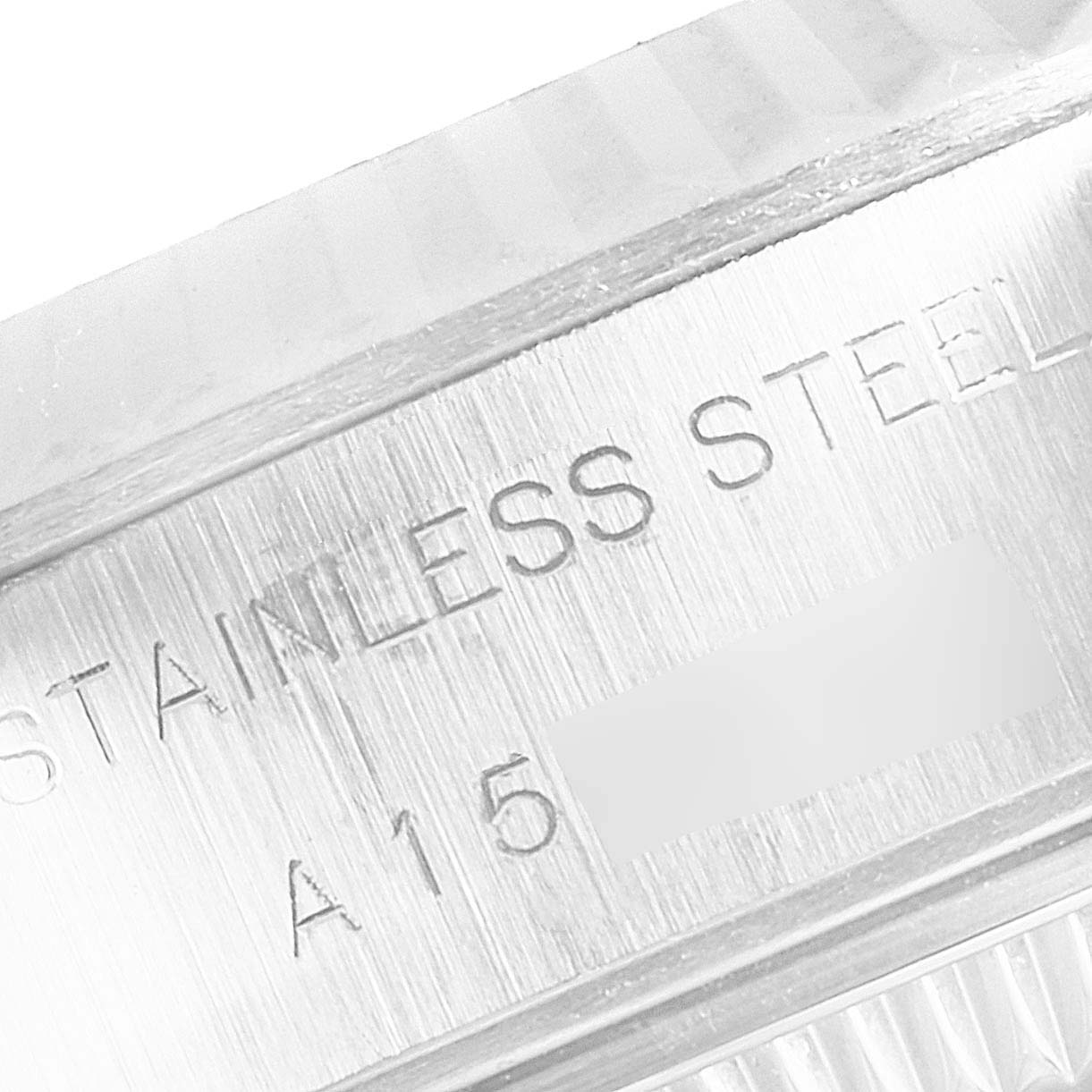 Close-up of the side engraving of a Rolex Datejust 69174 Women's Stainless Steel Silver Dial 69174 Women's Stainless Steel Silver Dial watch, showing "STAINLESS STEEL" and partial serial number.
