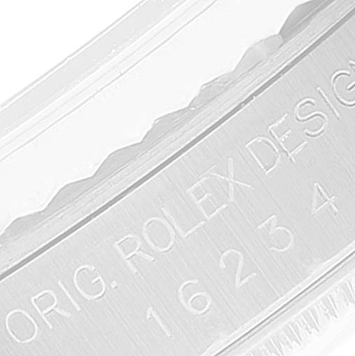 This image shows a close-up of the engraved text on the inner bezel of a Rolex Datejust 16234 Men's Stainless Steel Silver Dial 16234 Men's Stainless Steel Silver Dial watch.