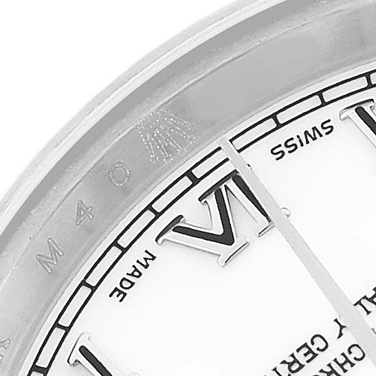 The image shows a close-up of the Rolex Datejust 179174 Women
s Stainless Steel White Dial dial and part of the bezel, highlighting Roman numerals and markings.