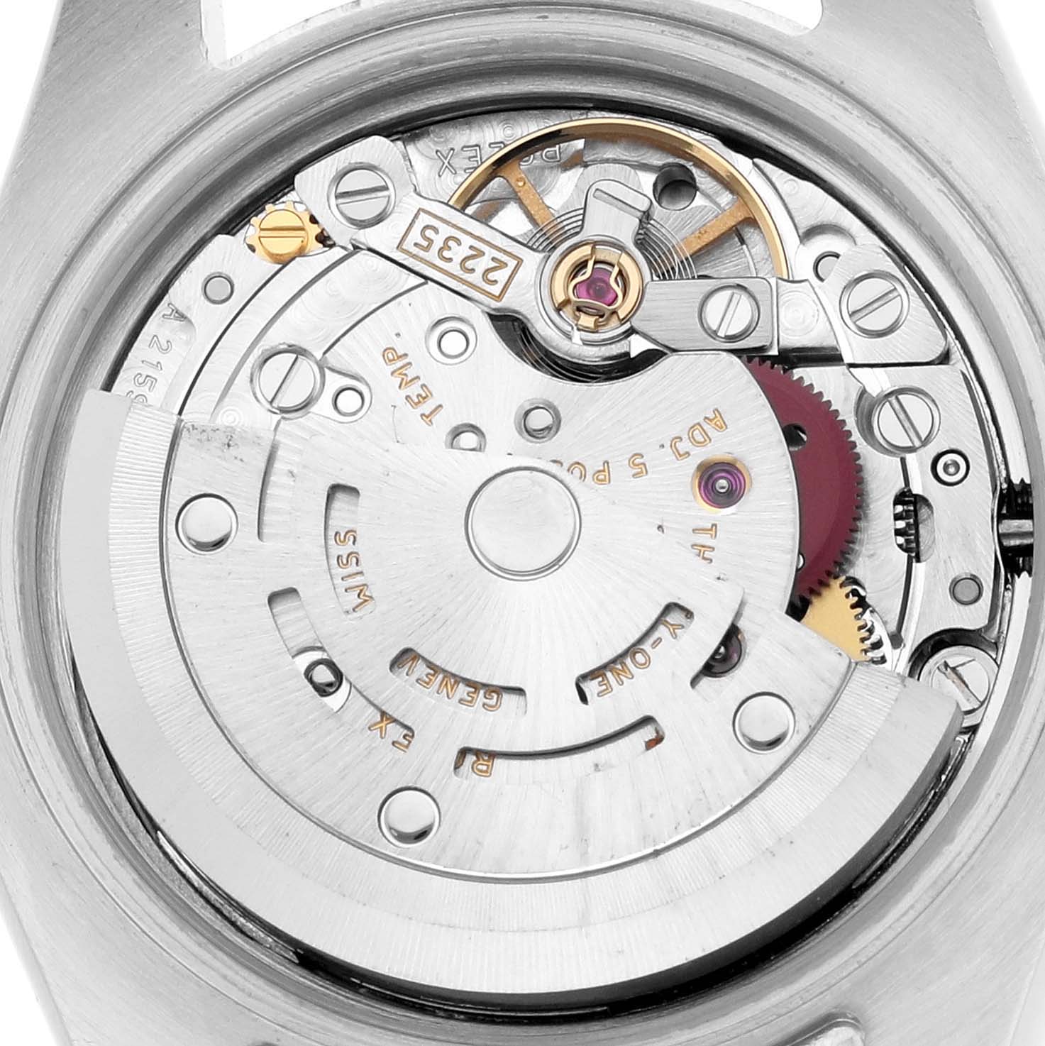 The image shows the inner mechanism of a Rolex Datejust 179174 Women
s Stainless Steel White Dial watch from a top-down view, highlighting gears and the rotor.