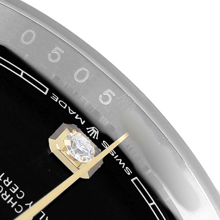 The image shows a close-up of the Rolex Datejust 126233 Men
s Steel and Gold (two tone) Black Dial dial, with focus on the hour marker, hands, and the edge of the bezel.