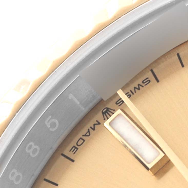 This image shows a close-up of the bezel, a part of the dial, and a watch hand from a Rolex Datejust 126233 Men
s Steel and Gold (two tone) Champagne Dial 126233 Men
s Steel and Gold (two tone) Champagne Dial watch.