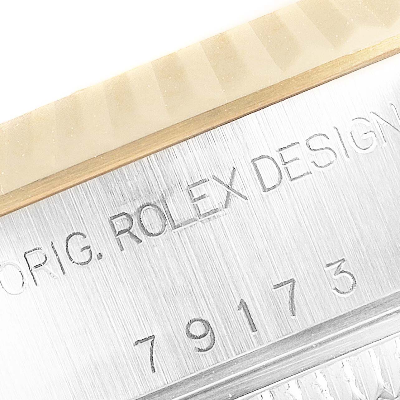 This image shows a close-up of the casing with engraved text and numbers of the Rolex Datejust 69173 Women's Steel and Gold (two tone) Champagne Dial 69173 Women's Steel and Gold (two tone) Champagne Dial watch.