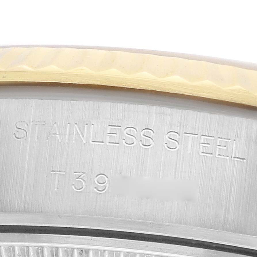 The image shows a close-up of the Rolex Datejust 69173 Women
s Steel and Gold (two tone) Champagne Dial
s stainless steel back, focusing on the edge and the inscription.